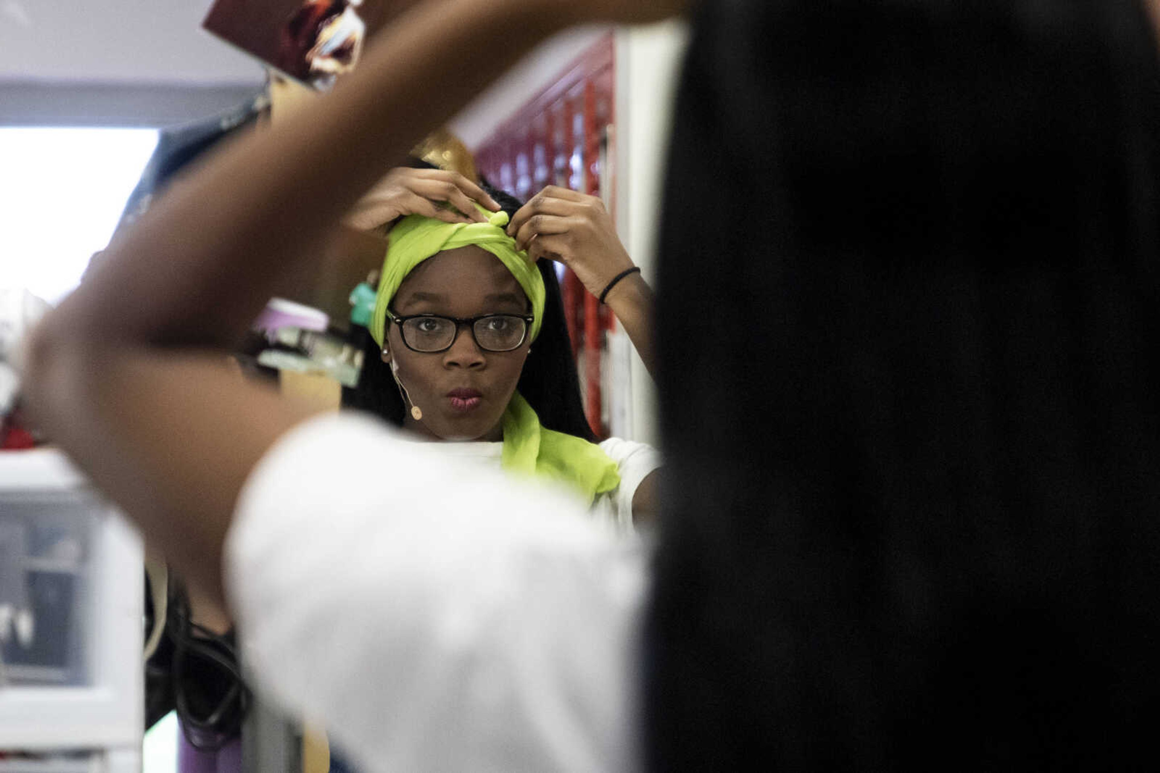 Peighton Robinson, 17, adjusts her scarf while preparing for her character portrayal of the character Donna Sheridan during Cape Central High School's spring musical production of "Mamma Mia!" Wednesday, April 10, 2019, in Cape Girardeau.