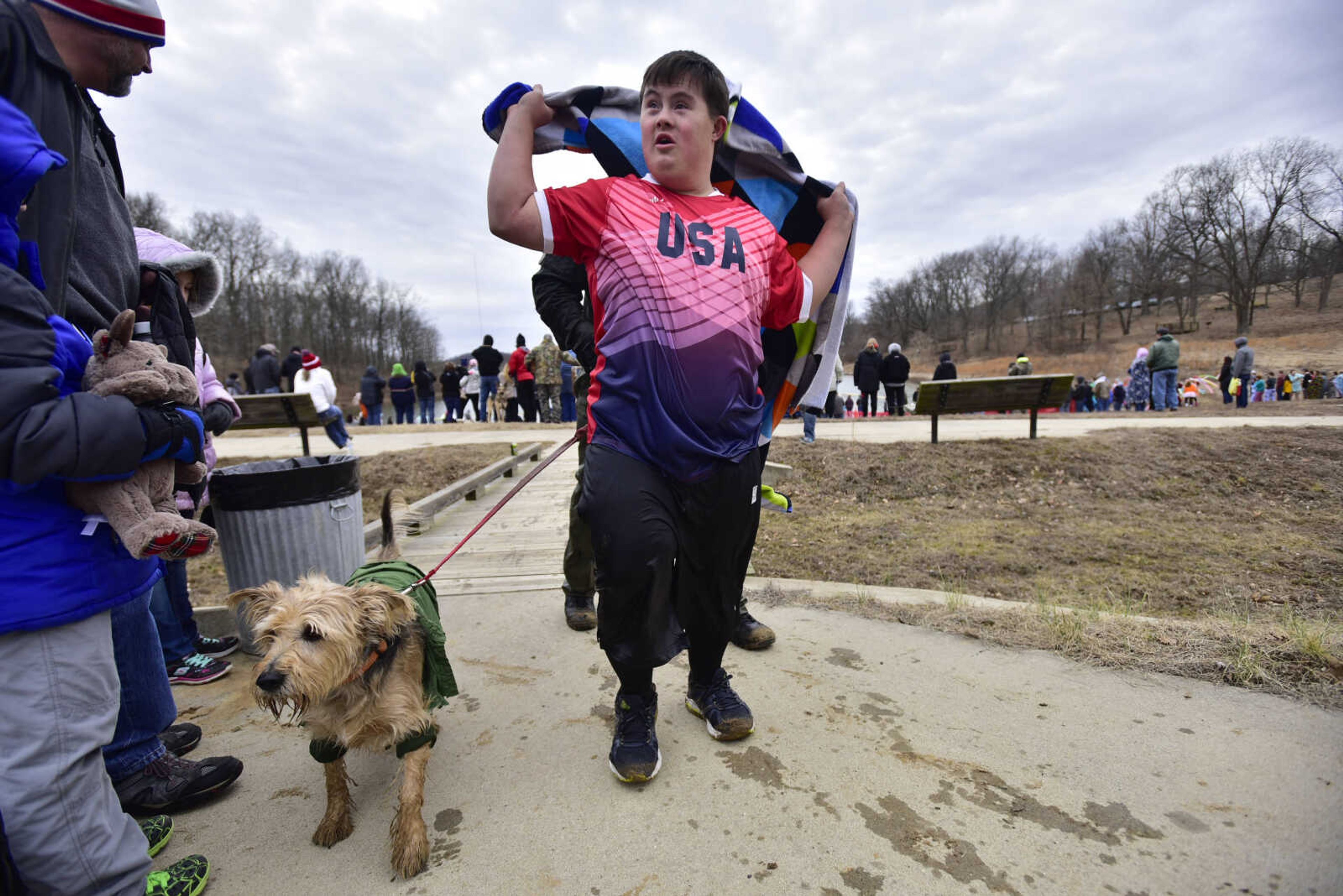 Logan Garner's towel blows in the wind as he walks to a heating area after participating in the Polar Plunge benefit for Special Olympics Missouri on Saturday, Feb. 3, 2018, at Trail of Tears State Park.