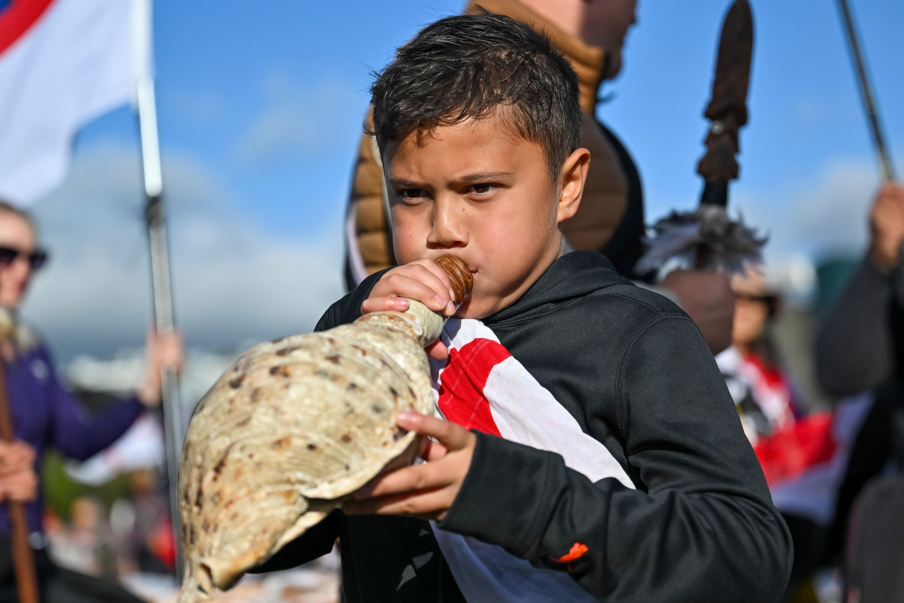 Te Haukūnui Hokianga plays a conch shell ahead of a protest at New Zealand's parliament against a proposed law that would redefine the country's founding agreement between Indigenous Māori and the British Crown, in Wellington, New Zealand, Tuesday, Nov. 19, 2024. (AP Photo/Mark Tantrum)