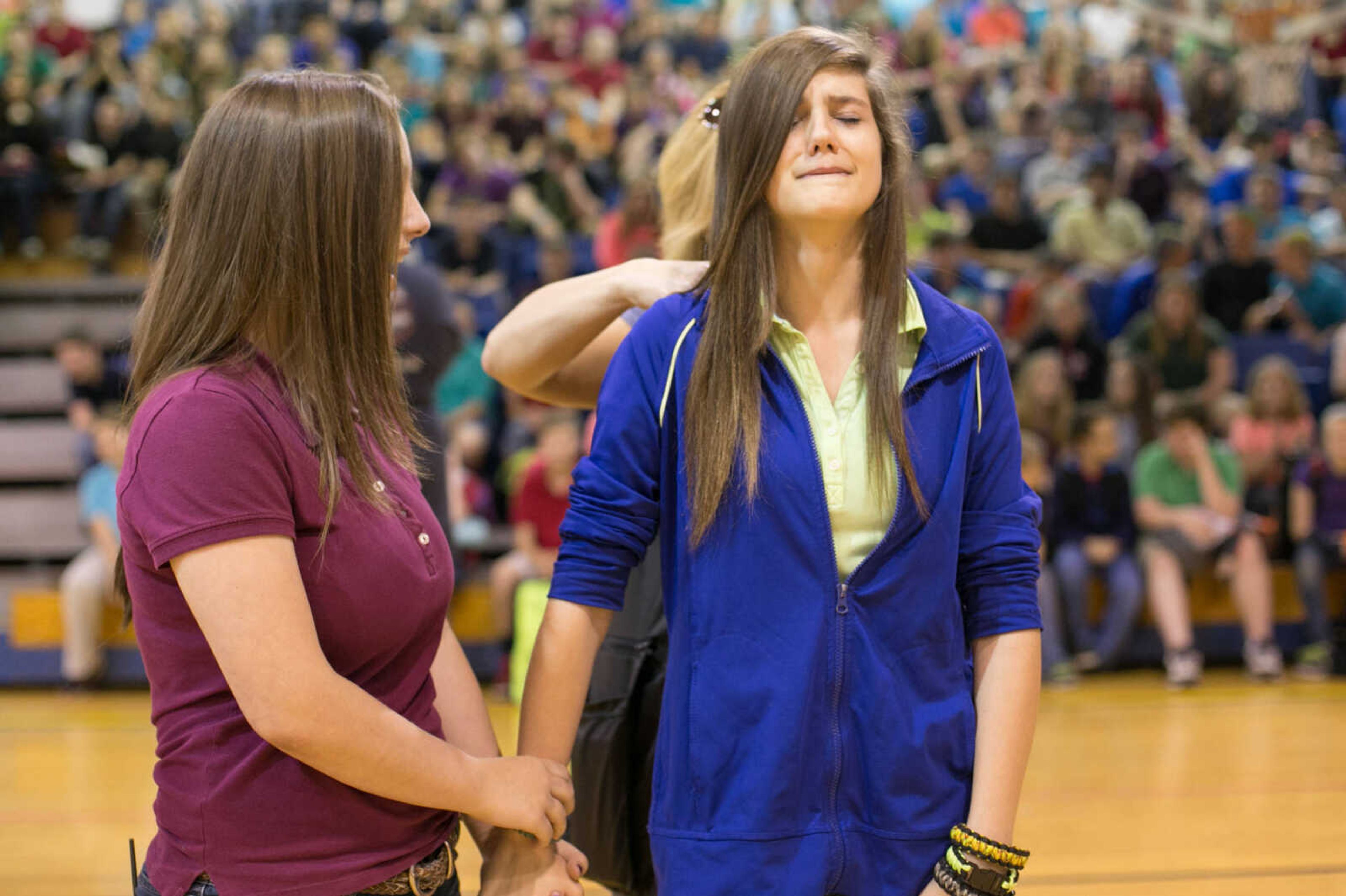 GLENN LANDBERG ~ glandberg@semissourian.com

Hailey Groesbeck consoles Sydny Eldridge as she has her hair cut and donated to the Beautiful Lengths program Monday, May 18, 2015 at Scott City High School. Twenty-four students and teachers participated in the event that provides wigs to cancer patients across the country.