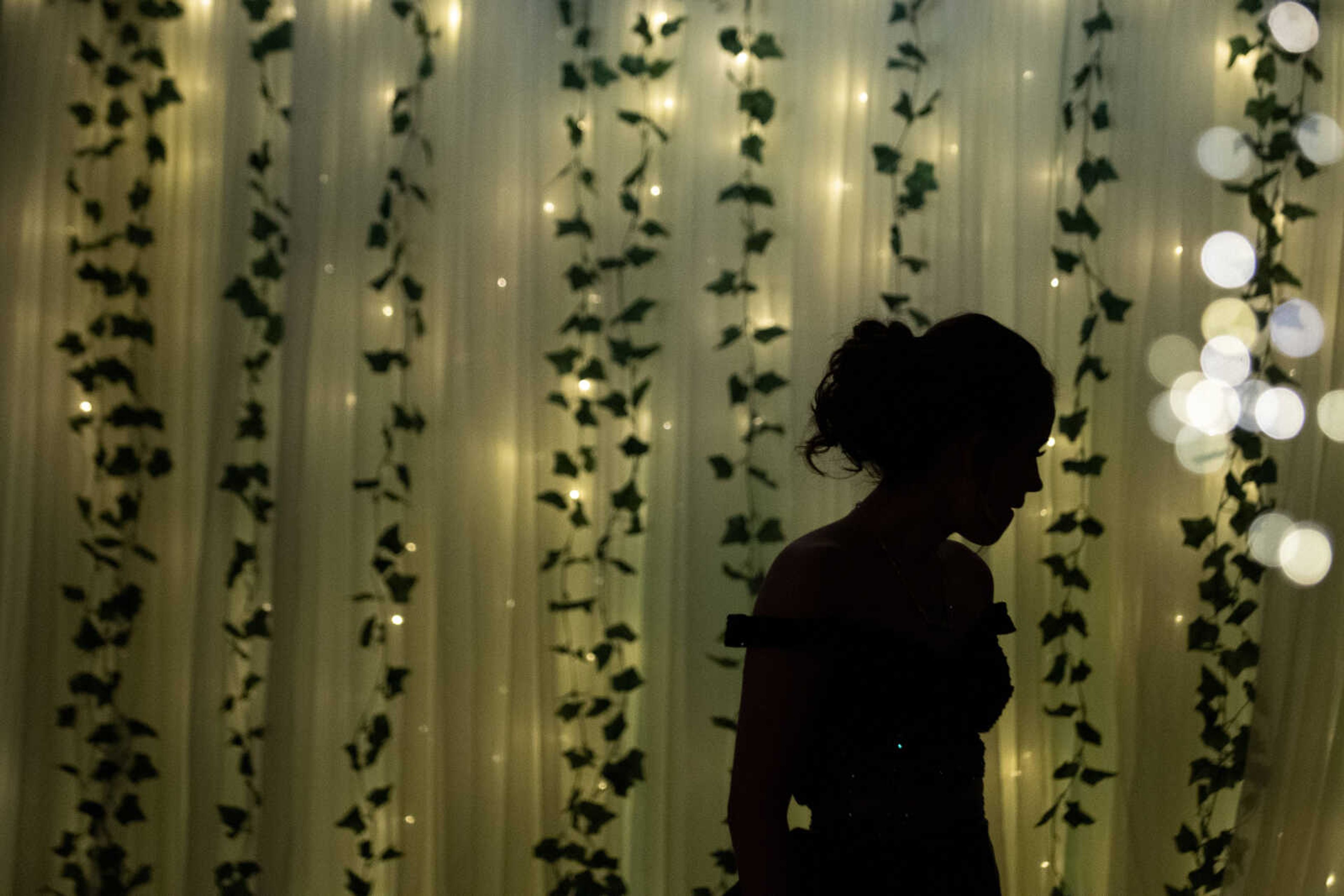 Delta sophomore Katelyn Lunsford is seen in front of decorations during Delta High School's prom on Saturday, April 13, 2019, at the Delta Community Center.