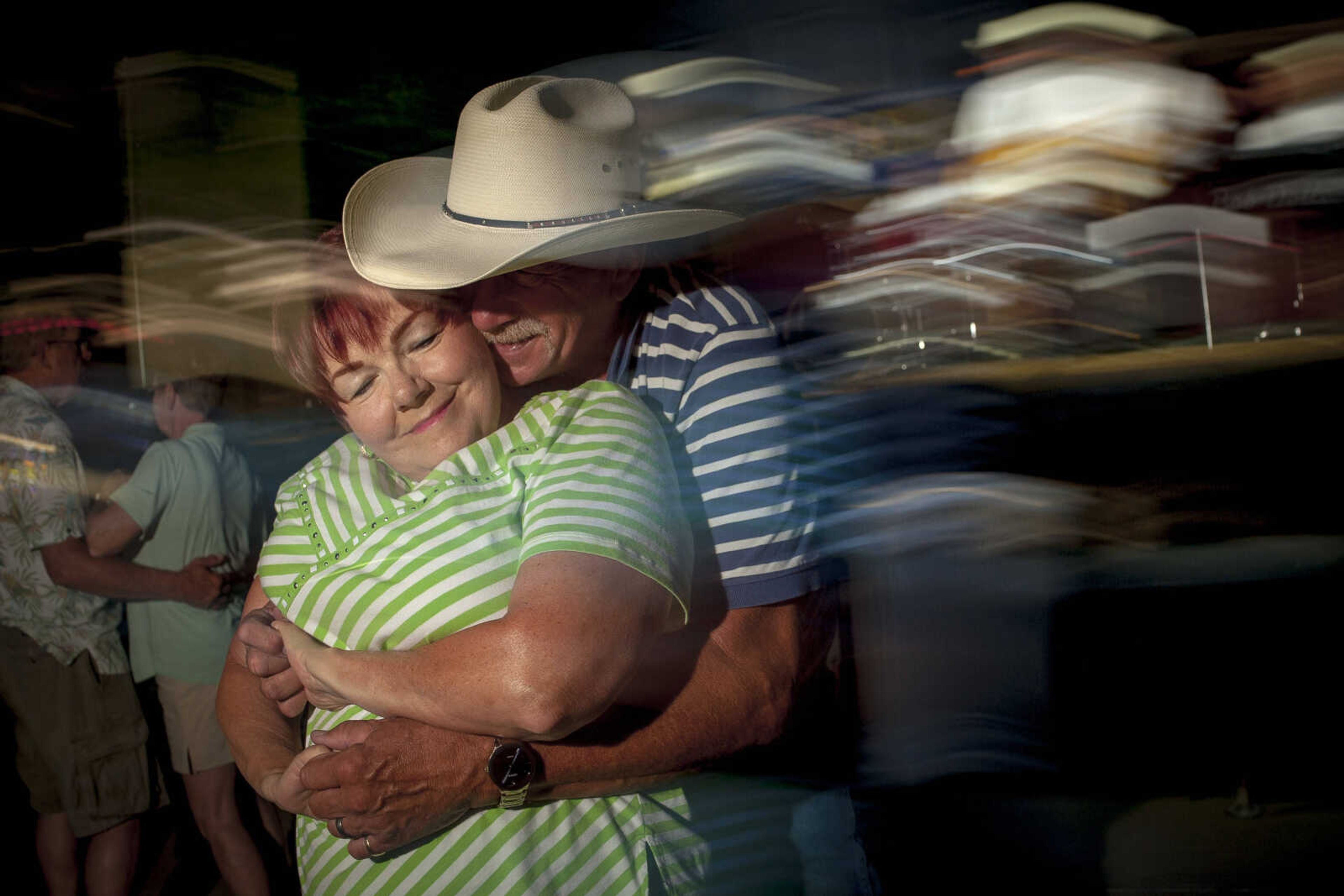 Donna Sinclair smiles while dancing with her husband, Rick, during the final day of Homecomers Saturday, July 27, 2019, in Uptown Jackson.