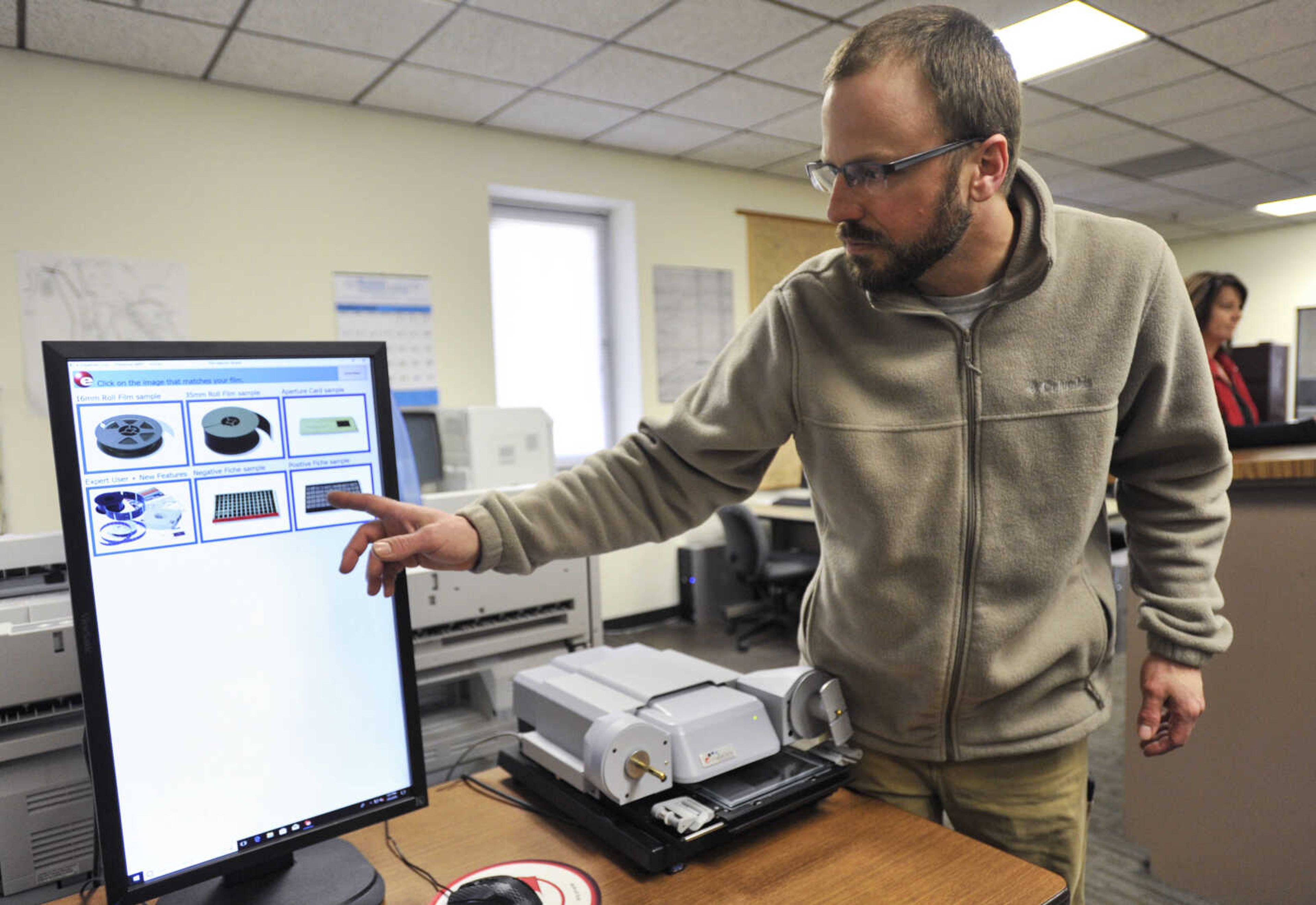 Cape Girardeau County recorder of deeds Andrew Blattner shows a high-definition digital microfiche reader and scanner Thursday, March 8, 2018, in the Recorder's Office at the Cape County Administration Building in Jackson.