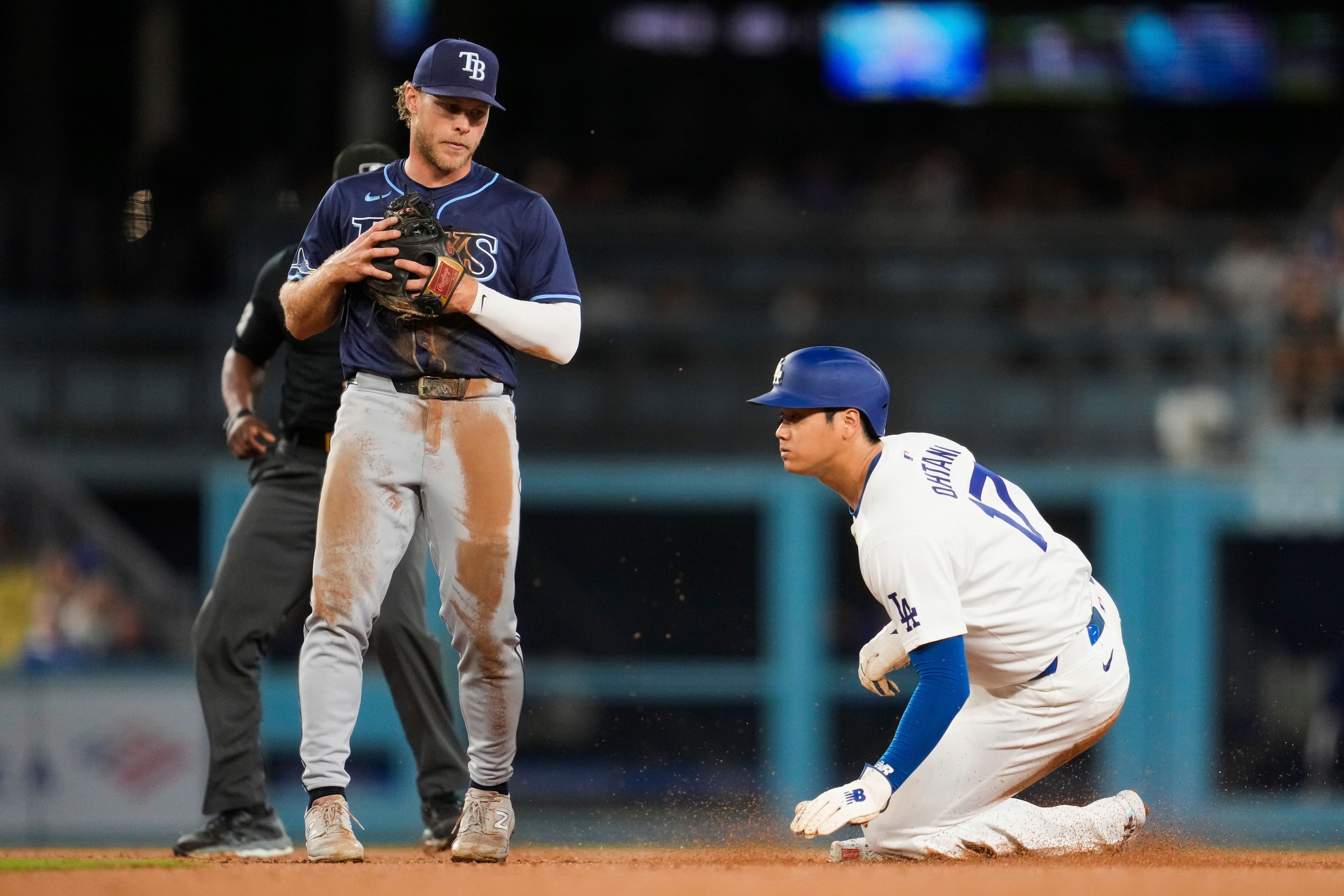 Los Angeles Dodgers designated hitter Shohei Ohtani (17) reacts after stealing second base during the fifth inning of a baseball game against the Tampa Bay Rays in Los Angeles, Friday, Aug. 23, 2024. (AP Photo/Ashley Landis)