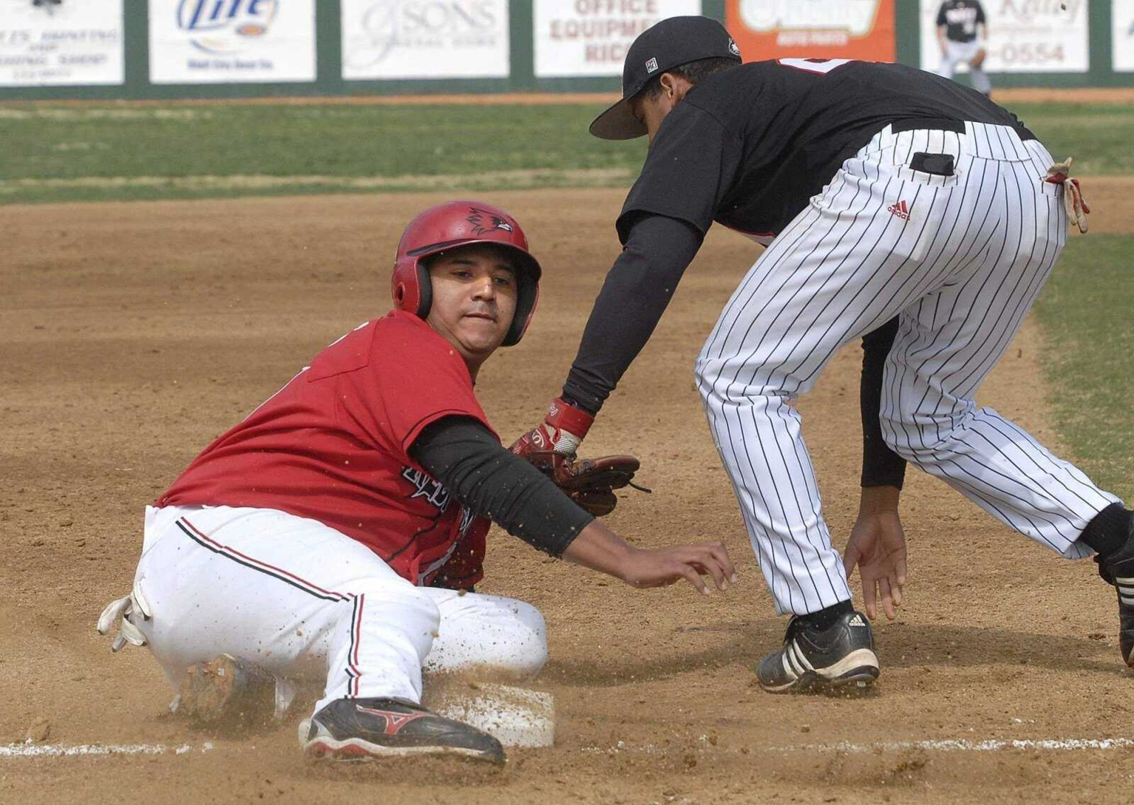 FRED LYNCH ~ flynch@semissourian.com<br>Southeast Missouri State's Tyrell Cummings steals third base as Northern Illinois' Troy White applies the late tag during the second inning Sunday at Capaha Field.