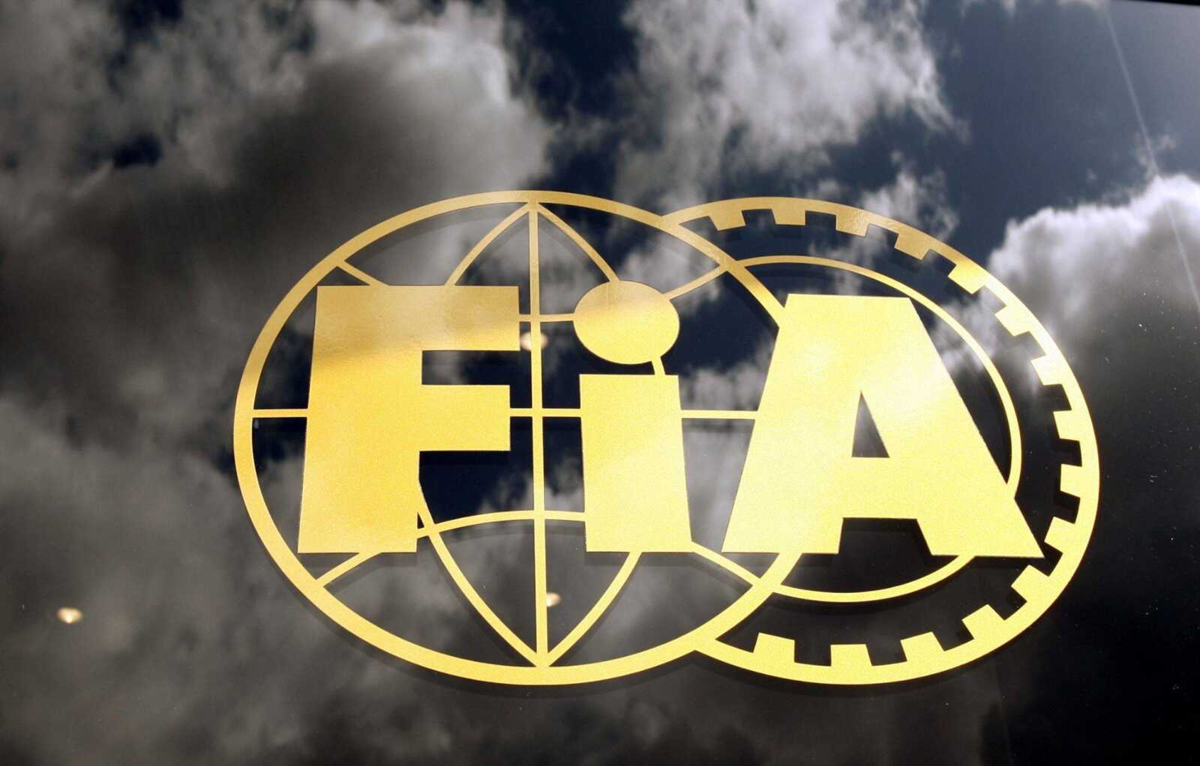 The FIA logo is seen on glass, with the sky reflected, during a free practice ahead the British Formula One Grand Prix at the Silverstone racetrack, in Silverstone, England, Friday, June 19 2009.  In a statement released by the Formula One Teams Association on Friday on behalf of BMW-Sauber, Brawn GP, Scuderia Ferrari, McLaren-Mercedes, Red Bull Racing, Renault, Scuderia Toro Rosso and Toyota, announcing a breakaway series after failing to resolve their dispute with the FIA. (AP Photo/Luca Bruno)