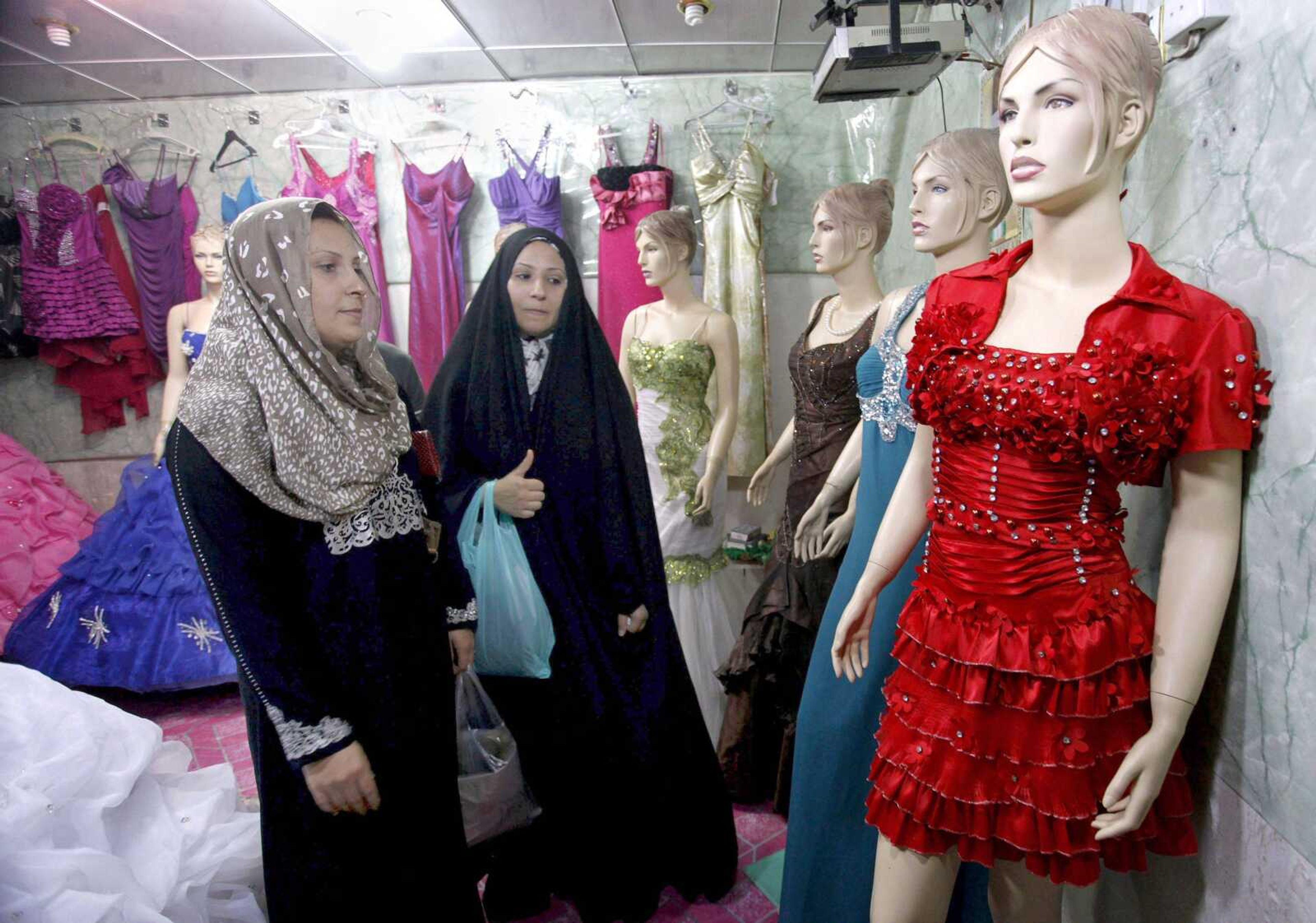 Iraqi women shop at a women&#8217;s fashion store Sunday in Diwaniyah, Iraq. (Alaa al-Marjani ~ Associated Press)