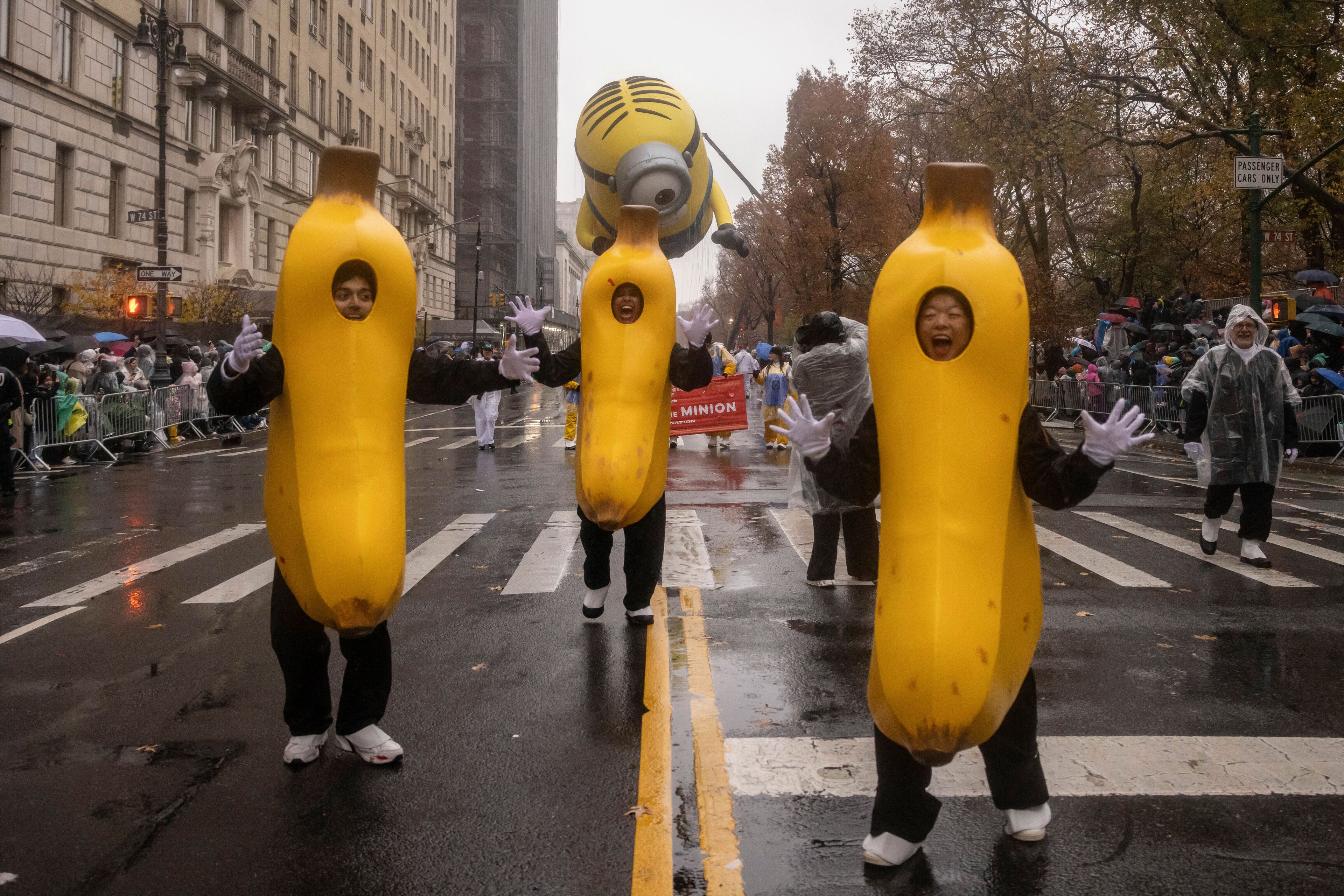 Parade performers lead the Stuart the Minion float down Central Park West during the Macy's Thanksgiving Day parade, Thursday, Nov. 28 2024, in New York. (AP Photo/Yuki Iwamura)