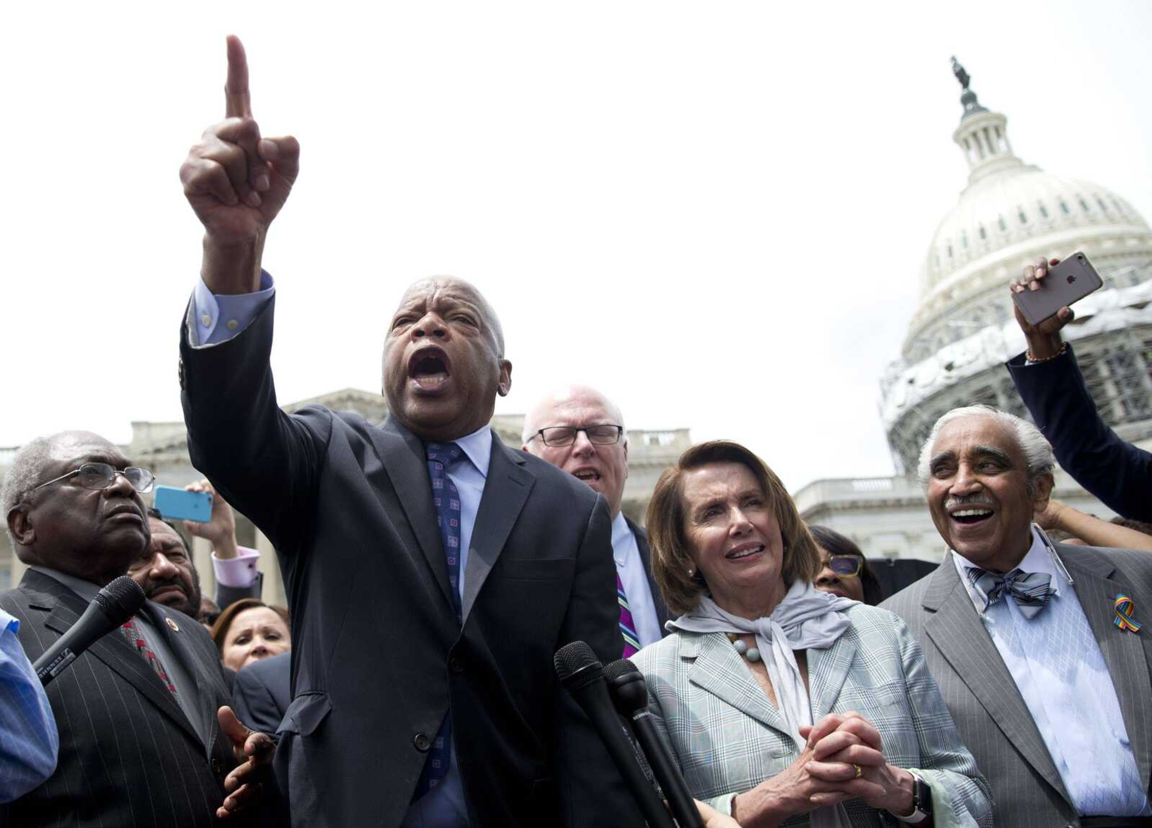 Rep. John Lewis, D-Ga., joined by other House Democrats, speaks Thursday on Capitol Hill in Washington after Democrats ended their sit-in protest on the House floor.