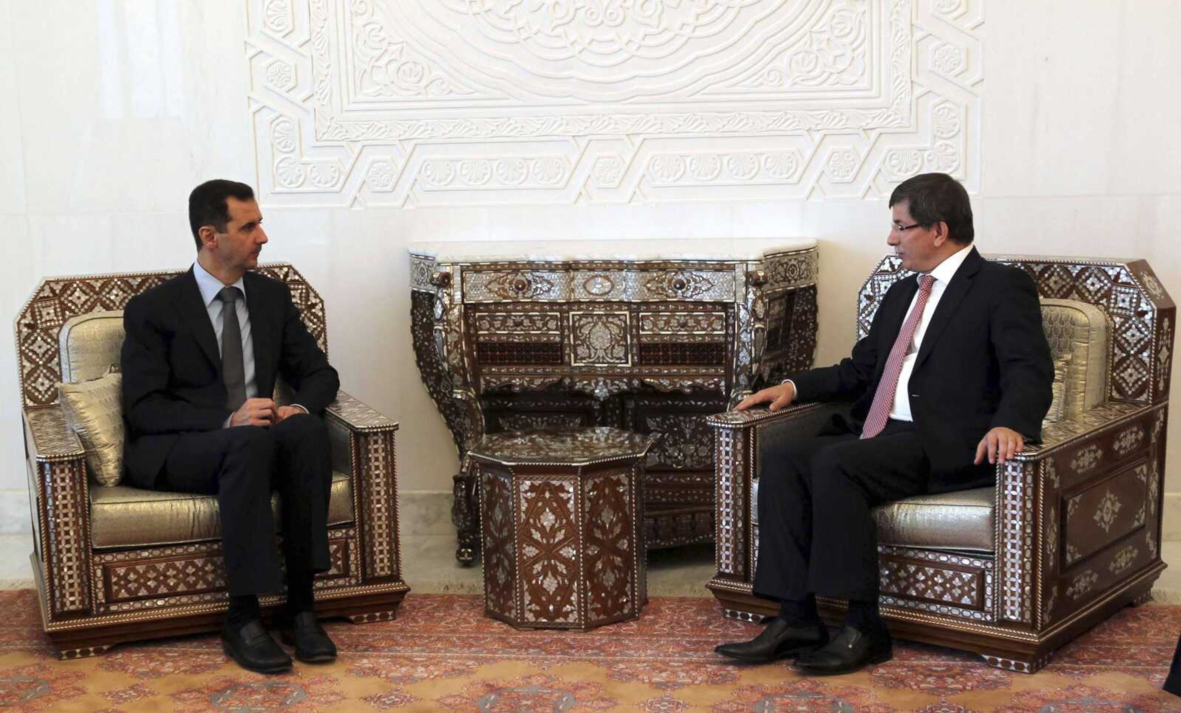 Turkish Foreign Minister Ahmet Davutoglu, right, meets with Syrian President Bashar al-Assad. in Damascus, Tuesday Aug. 9, 2011. Syria's president held talks with neighboring Turkey's foreign minister Tuesday as the regime faced a chorus of global reproach, with envoys from India, Brazil and South Africa also heading to Damascus to press for an end to the violent crackdown on a five-month-old uprising. (AP Photo/Hakan Goktepe, Anatolian) TURKEY OUT