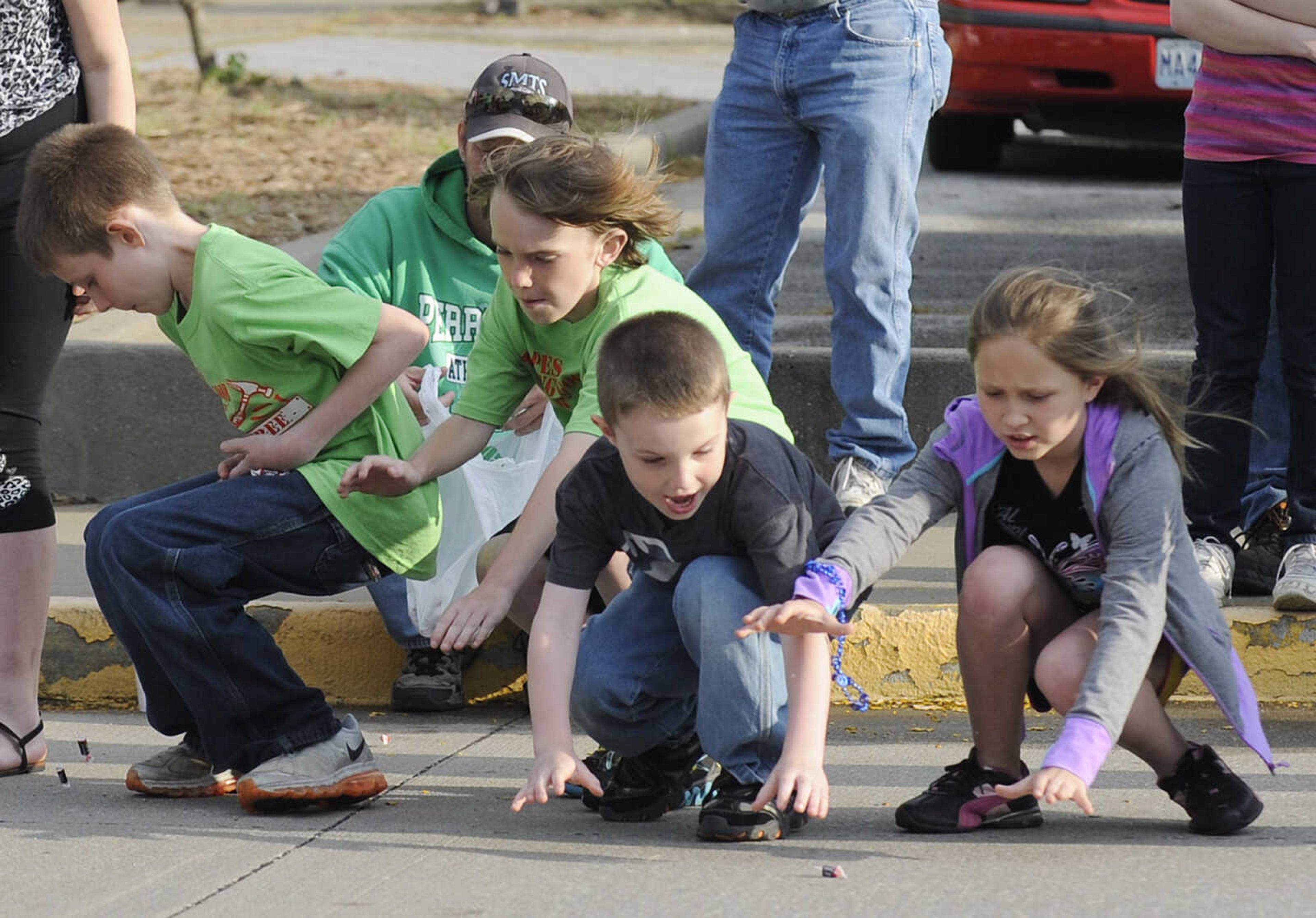 Children scramble for candy during the Perryville Mayfest Parade Friday, May 10, in Perryville, Mo. This year's Mayfest theme is Peace, Love, Perryville Mayfest.