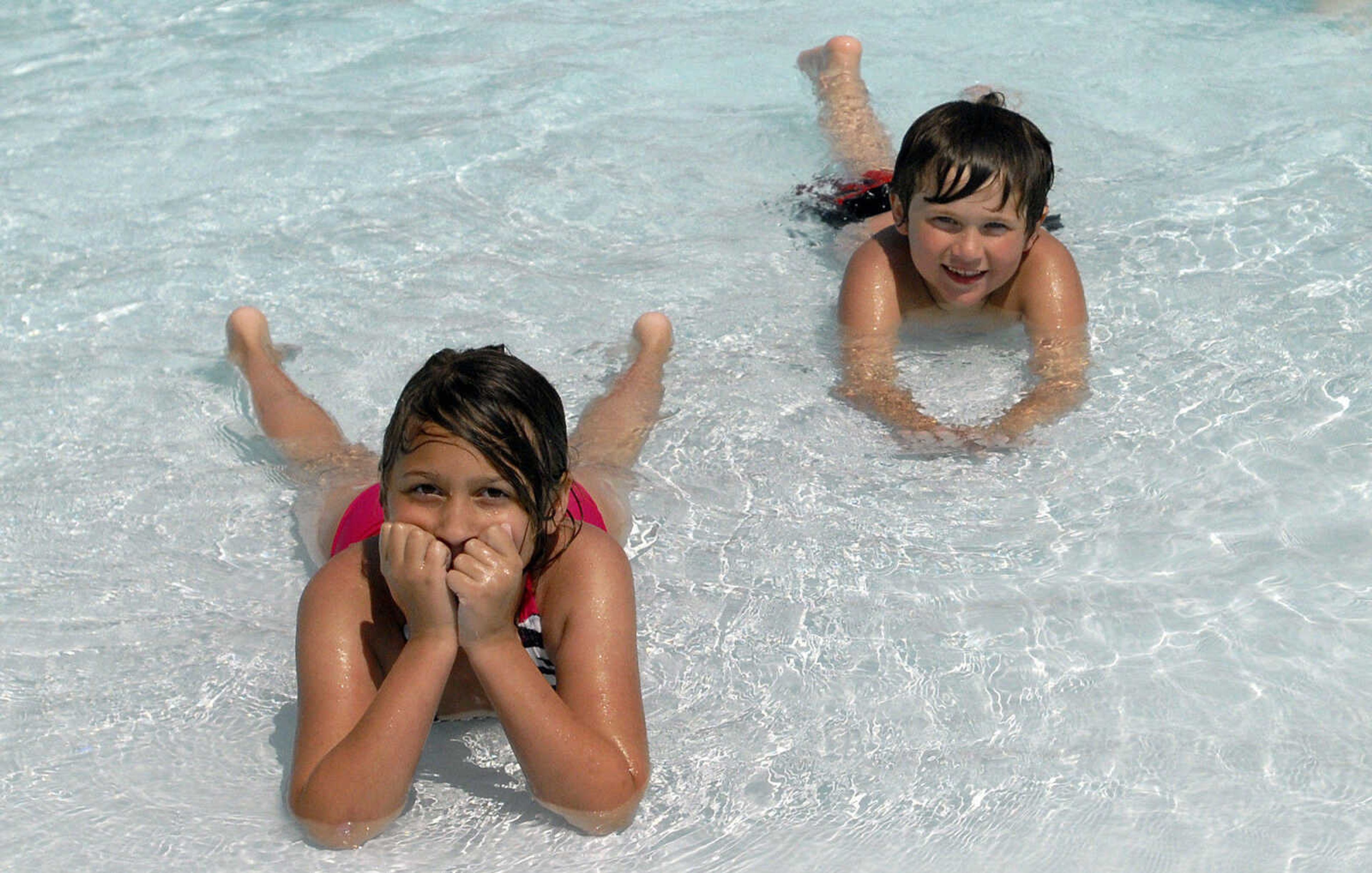 LAURA SIMON~lsimon@semissourian.com
Aaliyah Hurt and Braden DeRossett relax in the play pool Saturday, May 28, 2011 during opening day of Cape Splash Family Aquatic Center in Cape Girardeau.