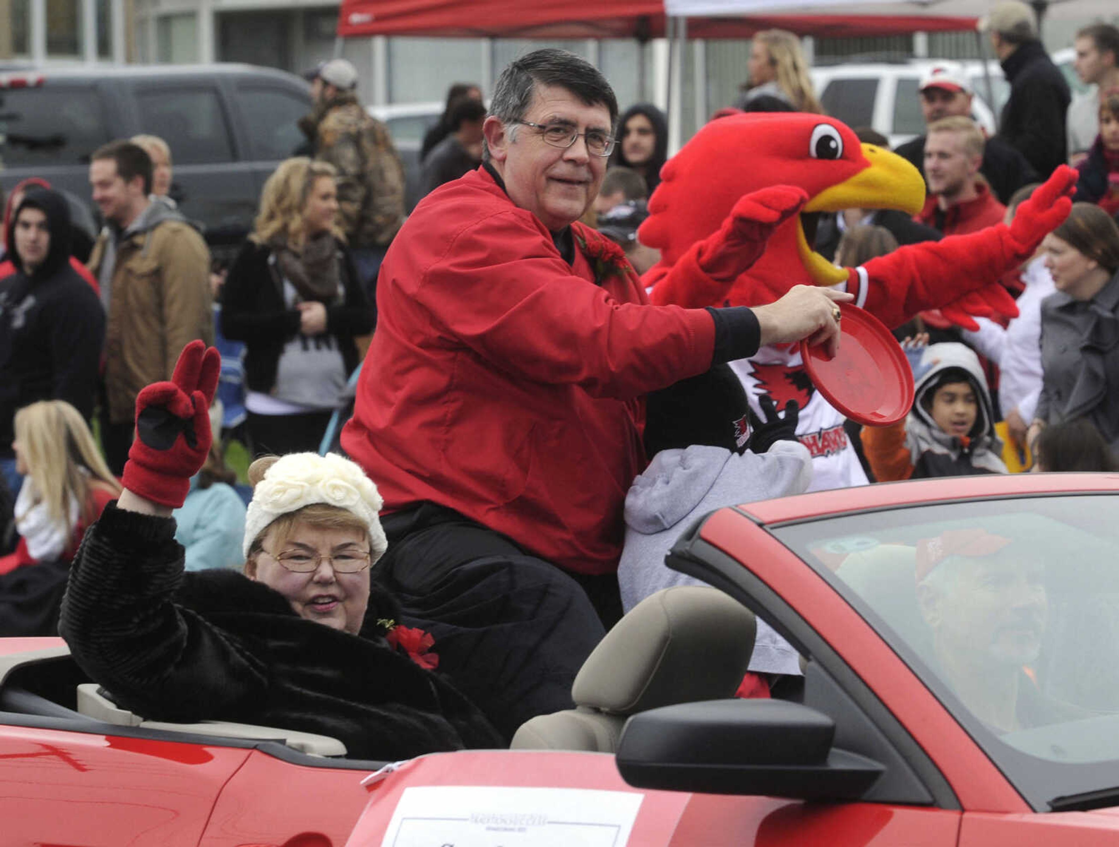 Kenneth Dobbins, president of Southeast Missouri State University since 1999, and his wife, Jeanine, ride in the SEMO Homecoming parade Saturday, Oct. 26, 2013 in Cape Girardeau.