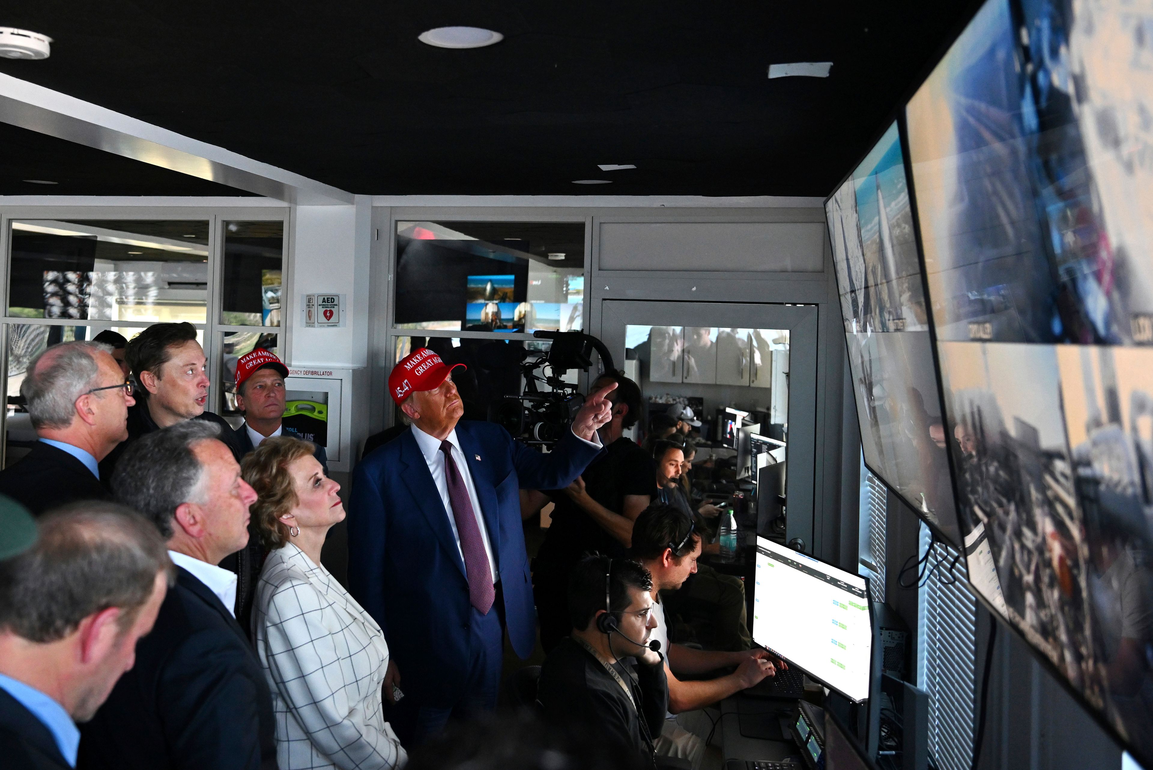 President-elect Donald Trump listens as Elon Musk explains the operations in the control room ahead of the launch of the sixth test flight of the SpaceX Starship rocket Tuesday, Nov. 19, 2024 in Brownsville, Texas. (Brandon Bell/Pool via AP)