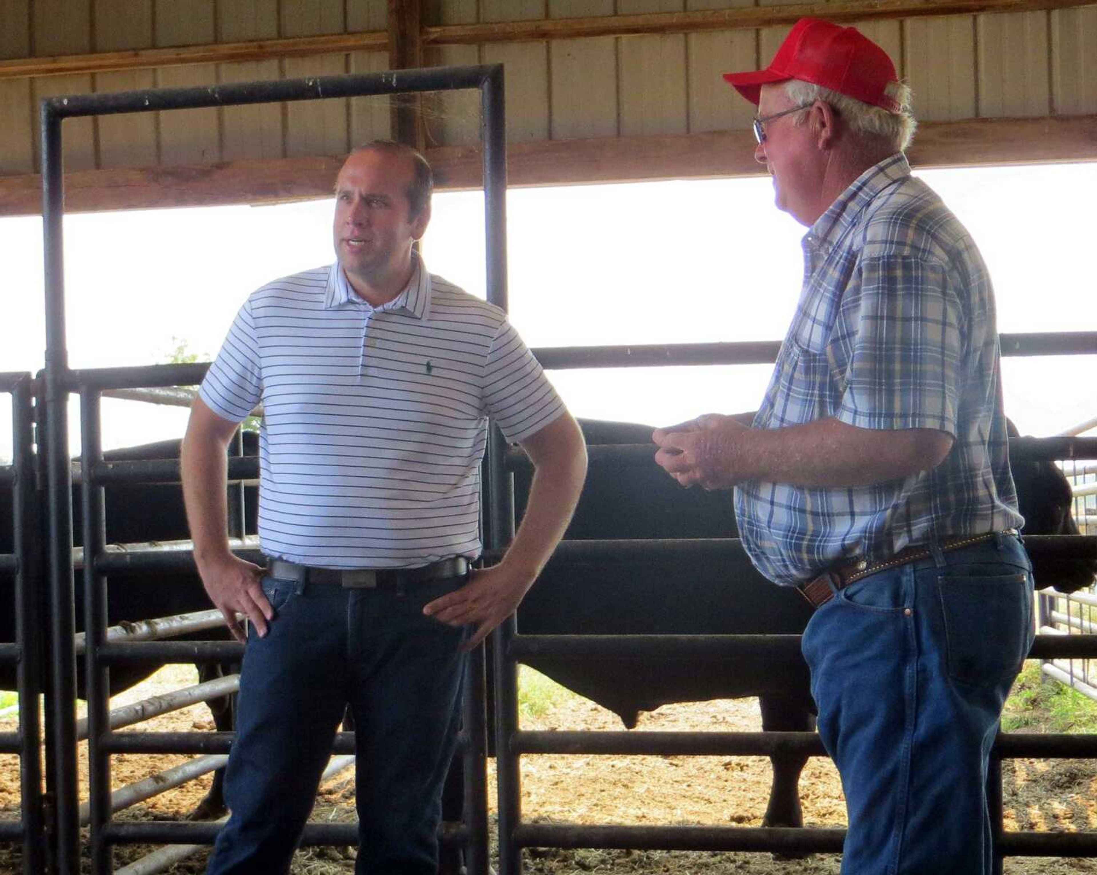 U.S. Rep. Jason Smith, left, stands with farmer Butch Meier on Monday at Butch's Angus near Jackson. The farm was one of the stops on Smith's annual farm tour. (SAMANTHA RINEHART)