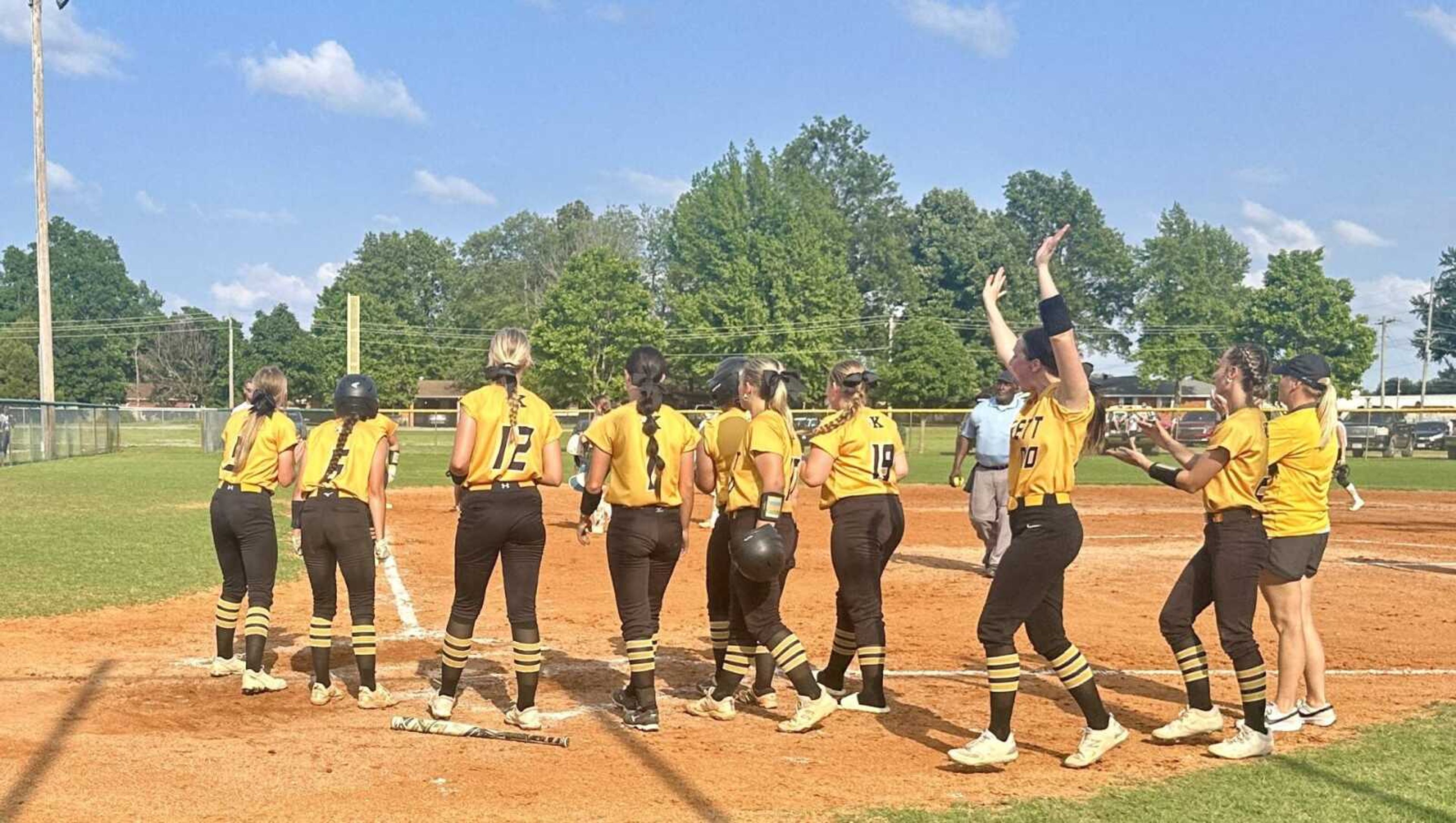 The Kennett Lady Indians welcome home Kynsly McCaig after her three-run scorcher over the left field fence Monday at the C2D1 Tournament at Malden.