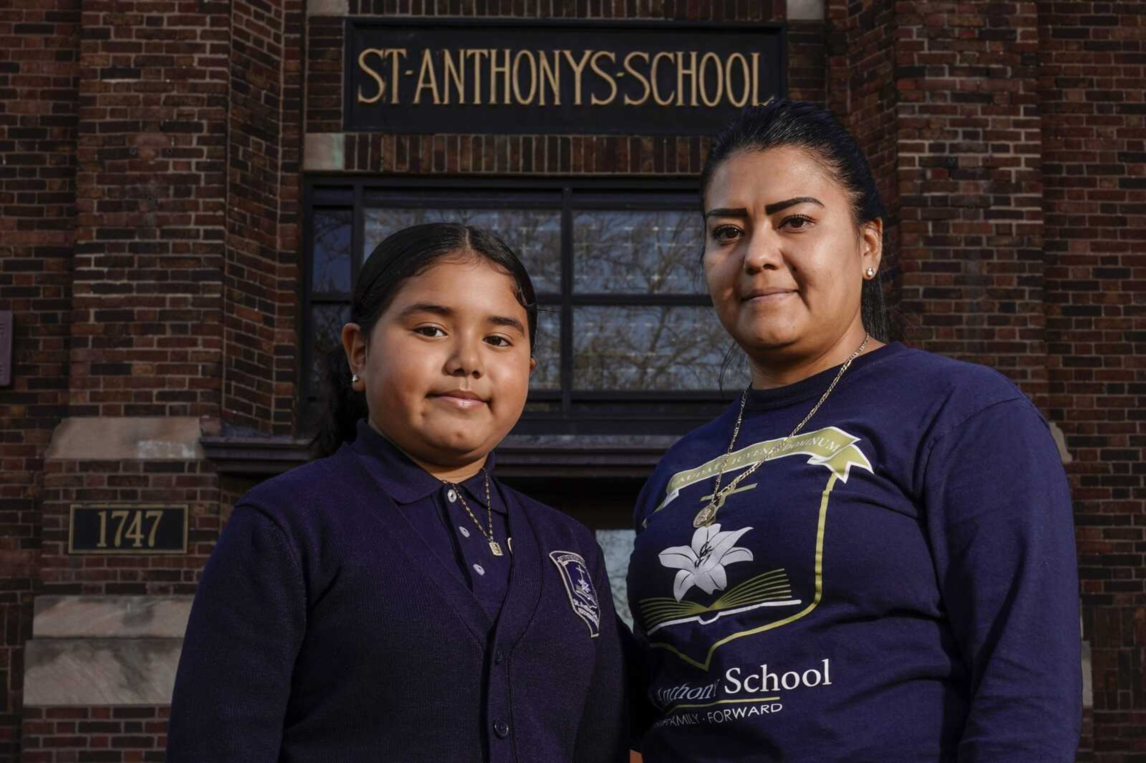 Lorena Ramirez poses with her daughter Citlalli outside St. Anthony School on Thursday, Oct. 20, in Milwaukee. School choice allows taxpayer money to pay for private school tuition instead of only financing public schools. "It's a huge difference because it's a support in faith and in values," said Ramirez, whose four children attend St. Anthony, walking distance from home on Milwaukee's south side.