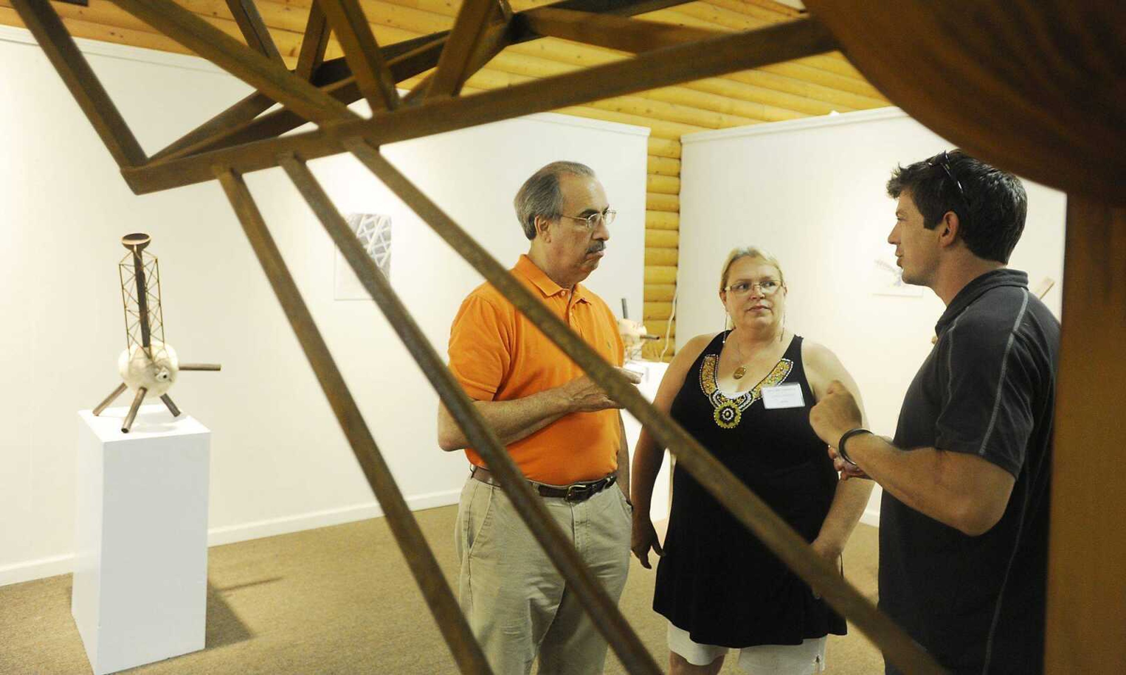 Nathan Pierce, right, talks with Sam Bishop, left, and Lynn Robey about his sculpture work at the Arts Council of Southeast Missouri, 32 N. Main St., during July's First Friday.