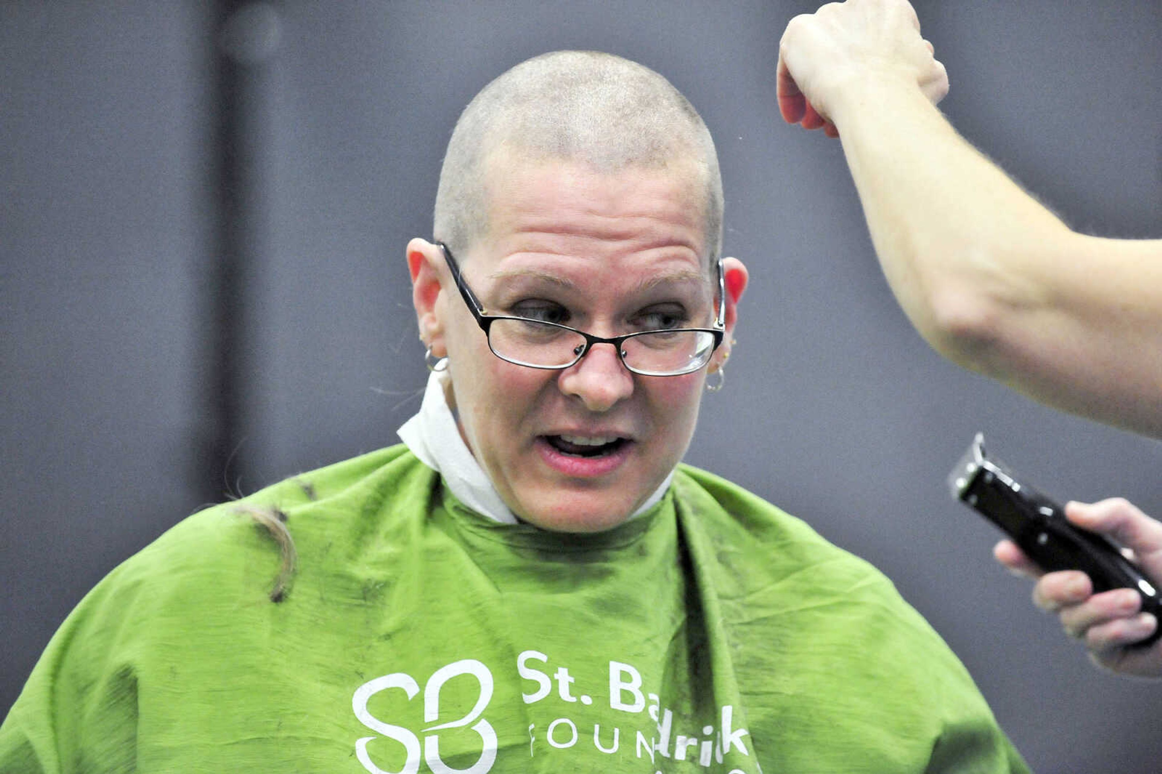 Jennifer Singleton reacts as April Whiteside shaves her head on Saturday, March 4, 2017, during the St. Baldrick's Foundation fundraiser at Old Orchard CrossFit in Jackson.