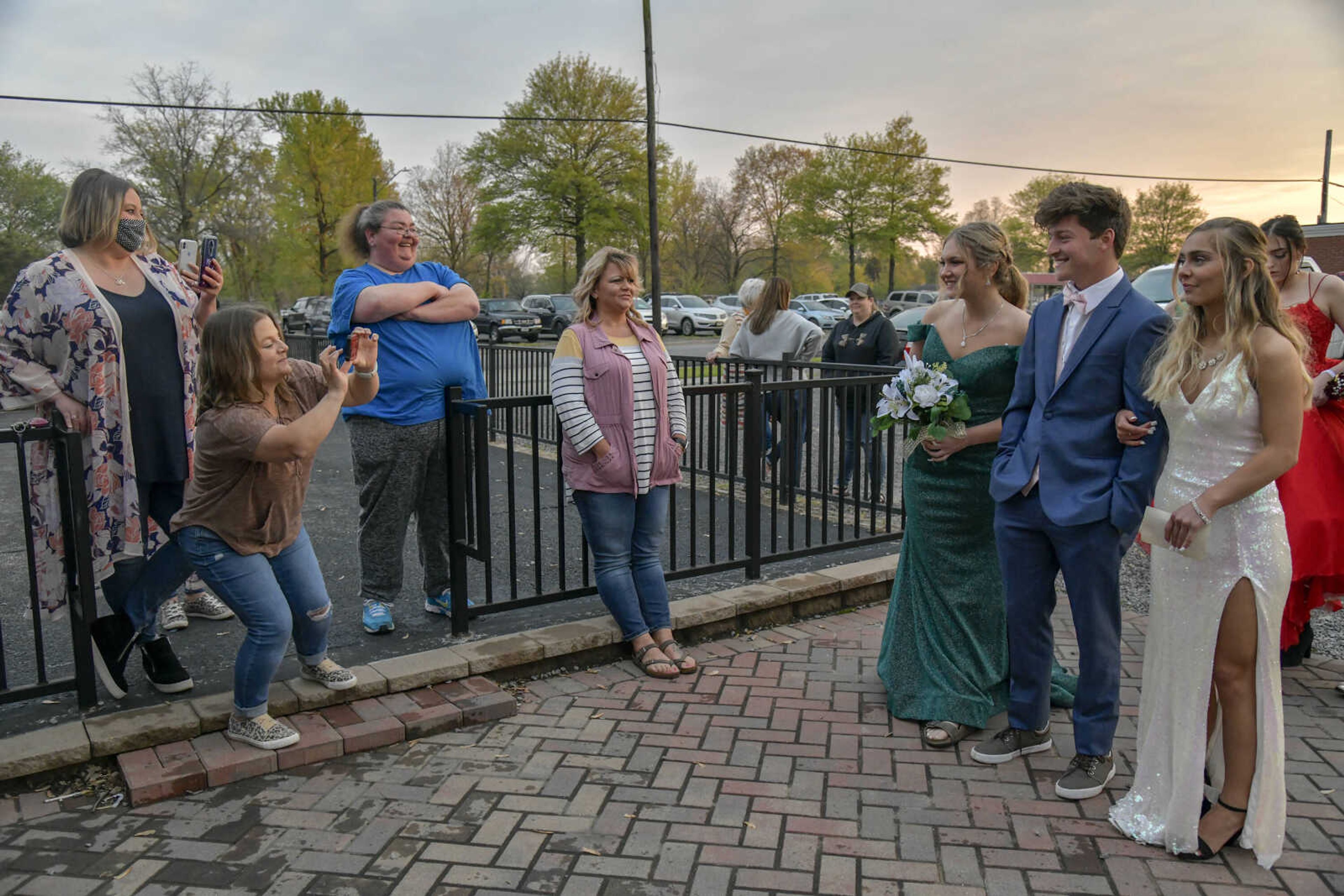 Family members take pictures of the students as they enter prom at the Front Porch in Scott City on Saturday, April 24, 2021.