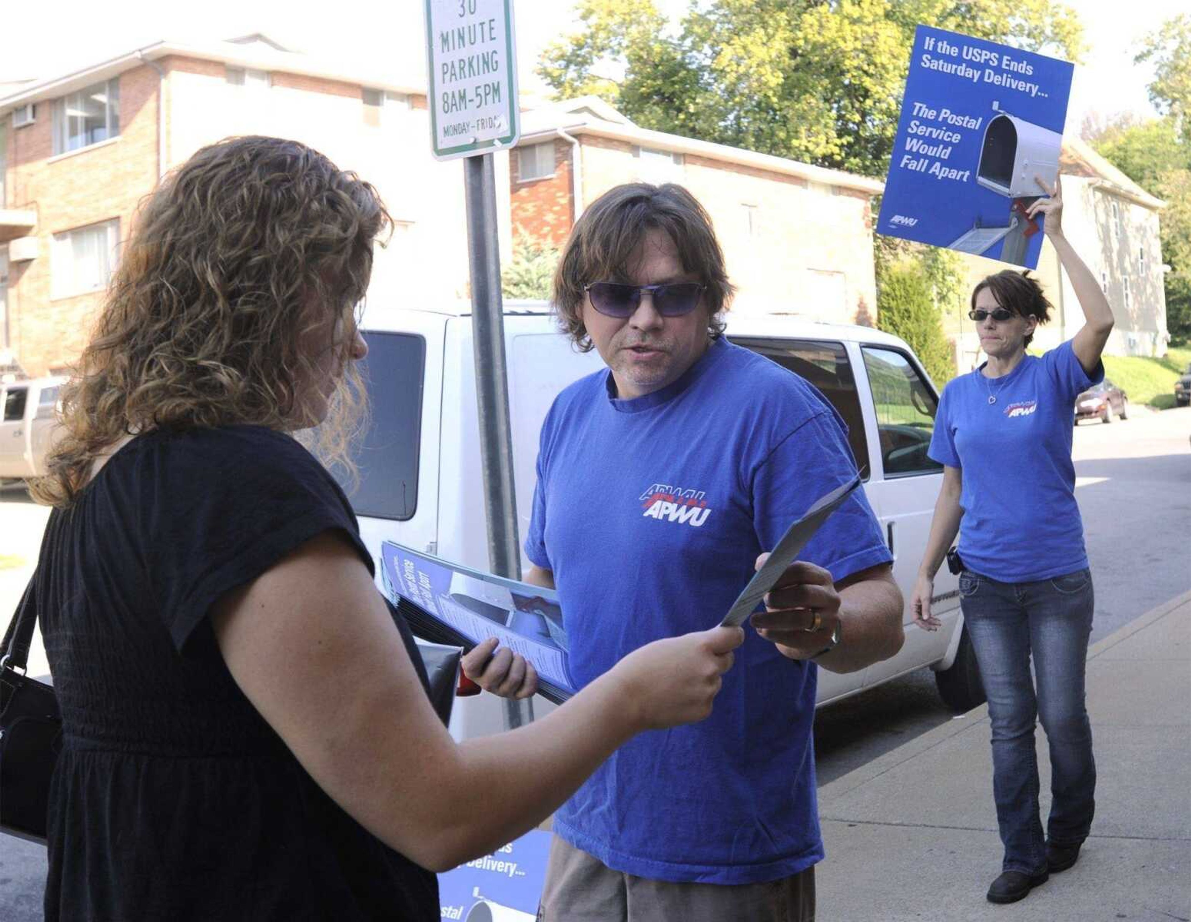 Greg Davidson, a member of Cape Girardeau Local 4088 of the American Postal Workers Union, talks to Alicia Christian outside the Cape Girardeau Post Office Monday Sept. 20, 2010. Davidson and Barbara Campbell were holding an informational picket to protest the plan by the U.S. Postal Service to stop Saturday mail delivery. (Fred Lynch)