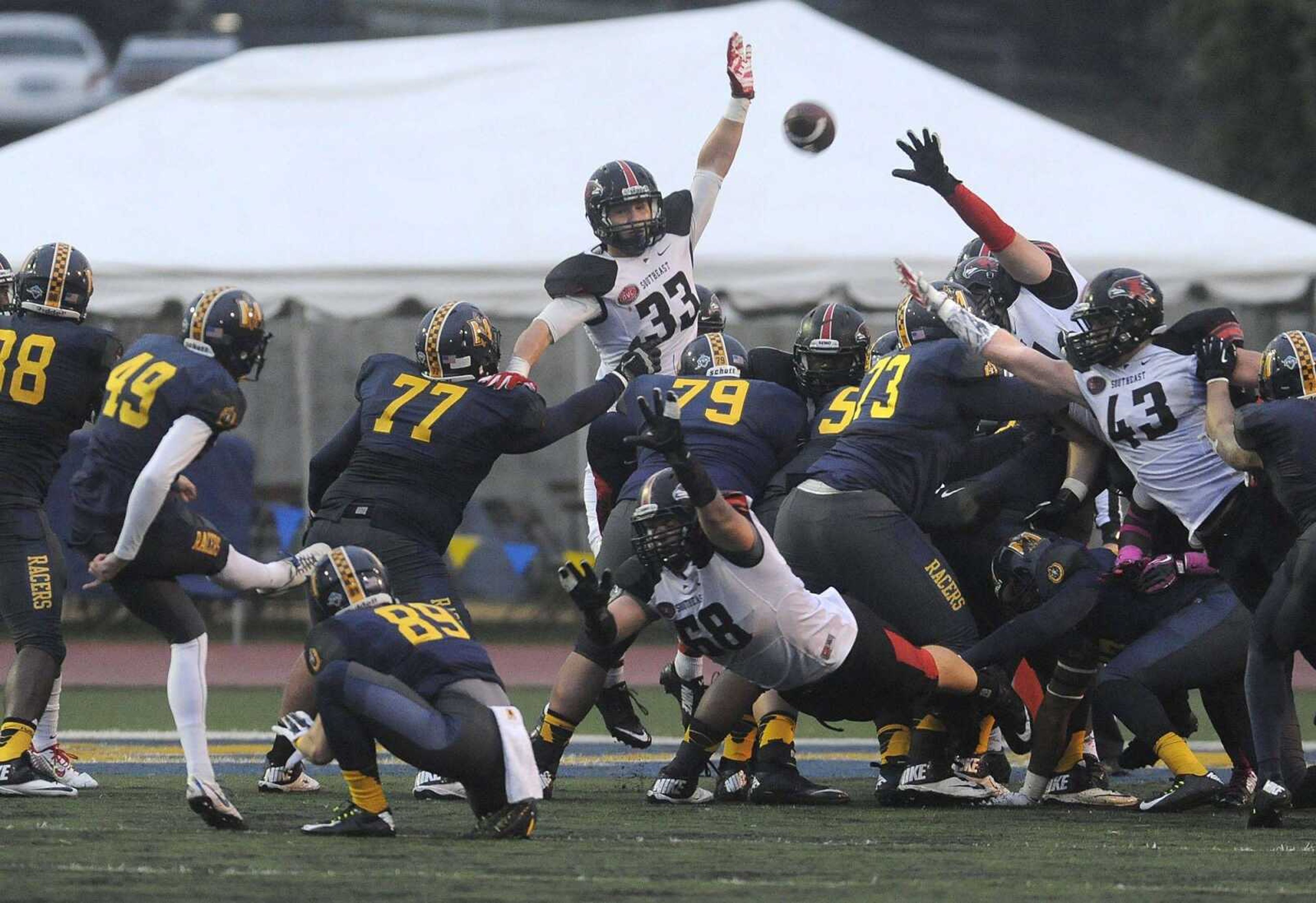 Members of the Southeast Missouri State football team attempt to block a PAT by Murray State's Carson Greifenkamp during a game last season in Murray, Kentucky. (Fred Lynch)