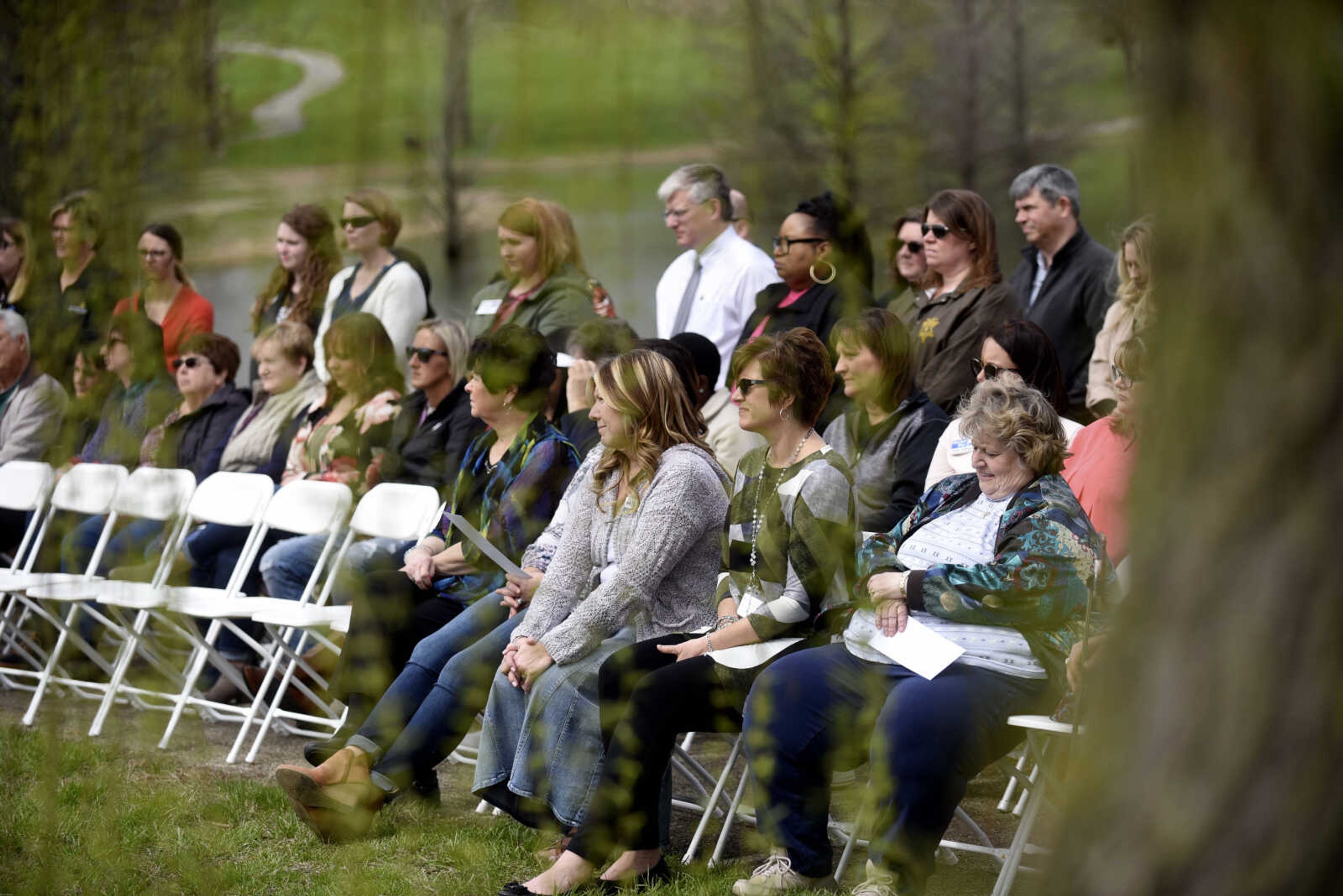 Community members listen to remarks at Cape County Park North for a symbolic ground-breaking ceremony for the new women's safe house on Friday, April 6, 2018, in Cape Girardeau.