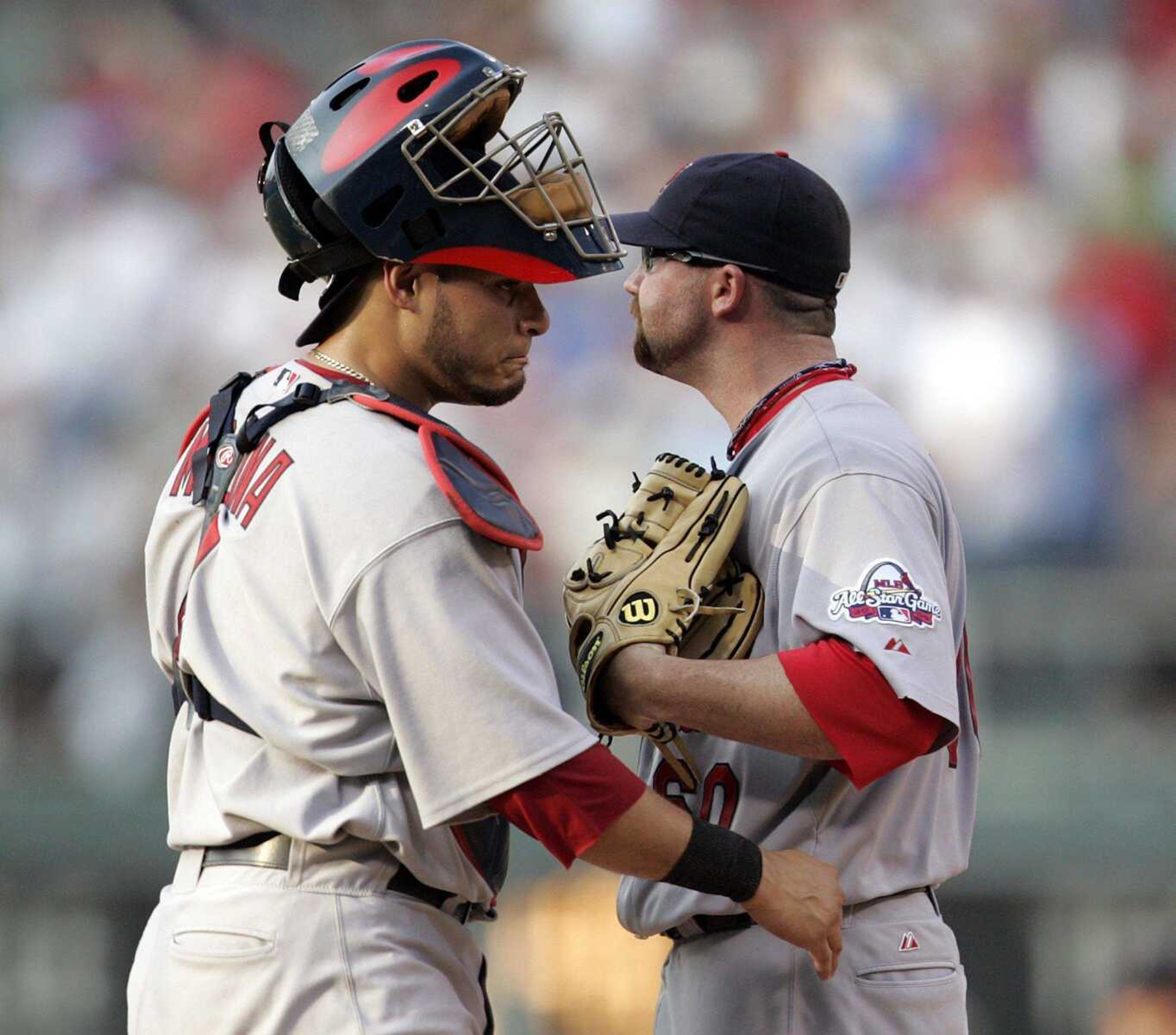 Cardinals catcher Yadier Molina, left, and relief pitcher Jason Motte stand on the mound following a grand slam by the Phillies' Jimmy Rollins during the sixth inning Saturday in Philadelphia. Mott gave up five runs in 1/3 of an inning. (Tom Mihalek ~ Associated Press)