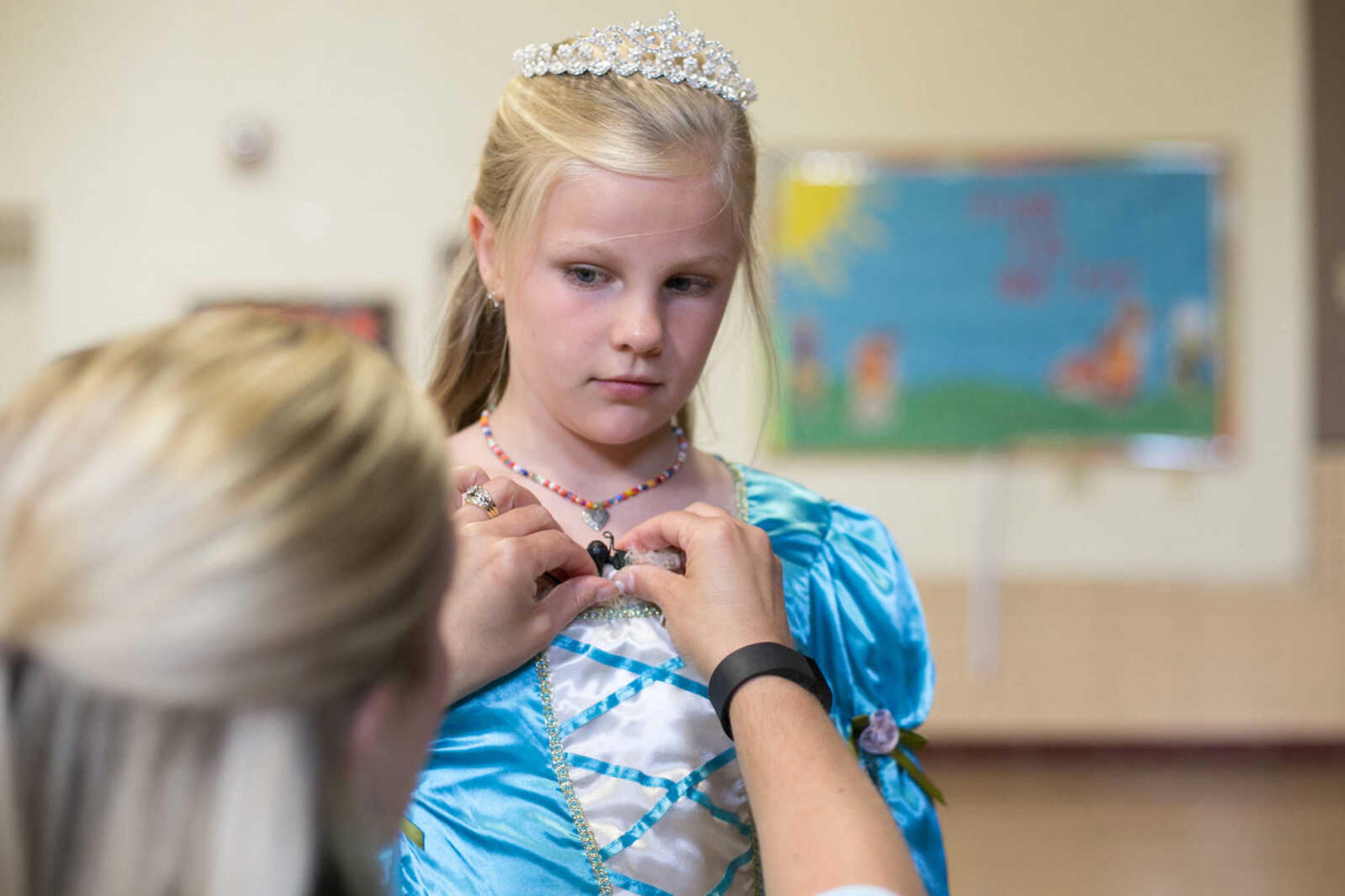 GLENN LANDBERG ~ glandberg@semissourian.com

Kyleigh Nickell gets help from her mother, Mindi,  pinning a microphone on during a dress rehearsal of "The Princess and the Pea" Tuesday, May 10, 2016 at Alma Schrader Elementary School in Cape Girardeau.