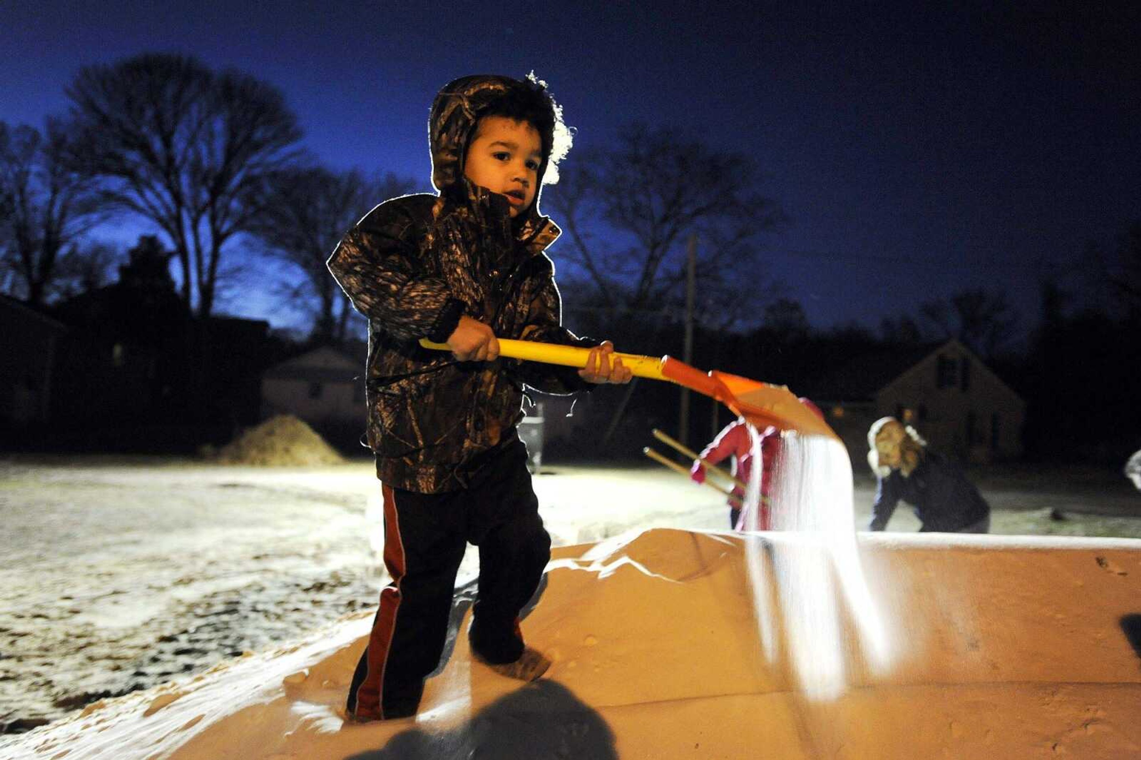 Four-year-old volunteer Zeke Sumner swings his shovel full of sand around to fill a sandbag outside the Red Star Baptist Church on Friday evening in Cape Girardeau. Sumner brought his own shovel Friday because the shovels that were there Thursday were too big for him to use properly. (Laura Simon)