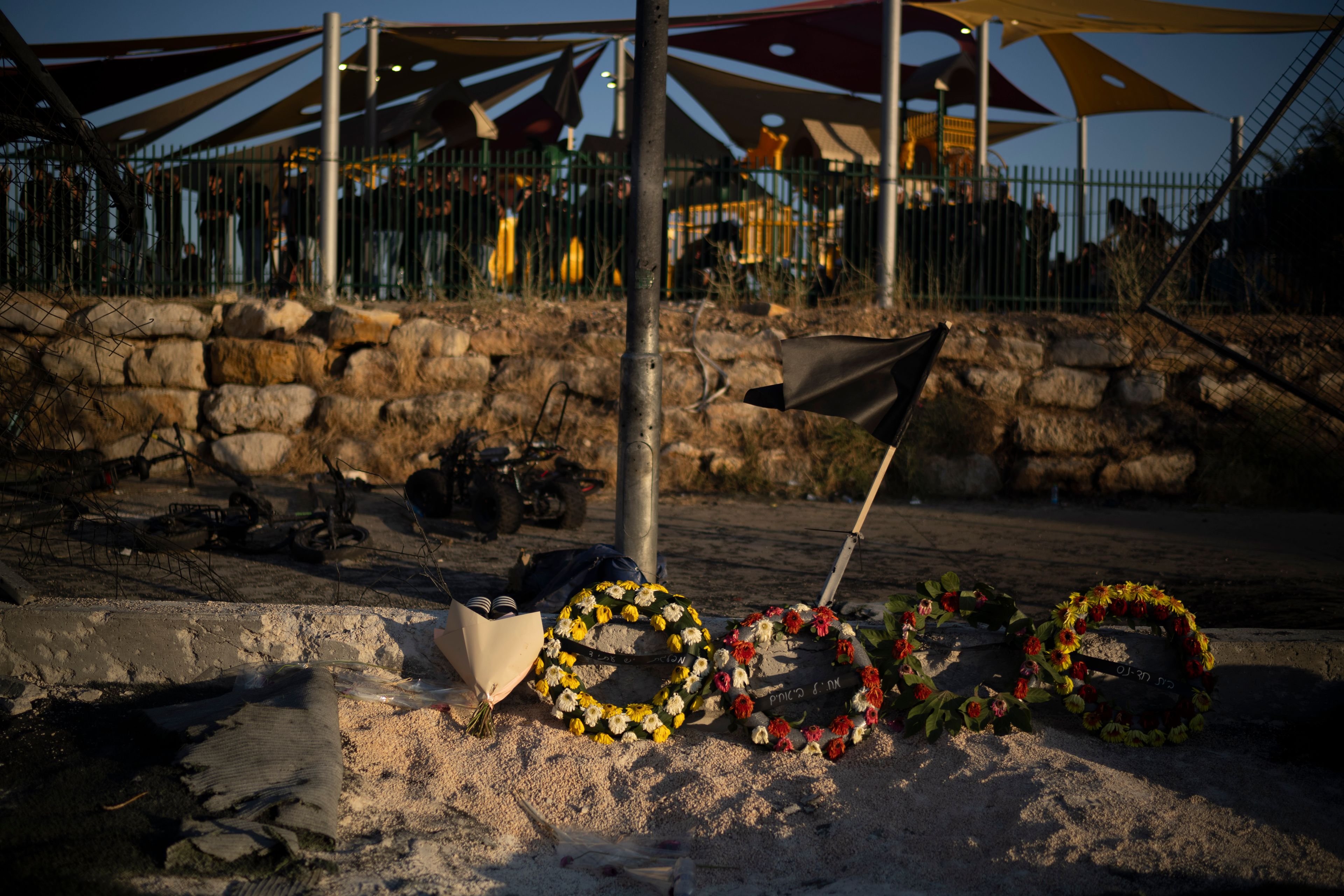 Wreath of flowers are placed on the site of a rocket's strike killing children and teens at a soccer field in the village of Majdal Shams, in the Israeli-annexed Golan Heights, Sunday, July 28, 2024. A rocket strike at a soccer field in the village has killed at least 12 children and teens. It's the deadliest strike on an Israeli target along the country's northern border since the fighting between Israel and the Lebanese militant group Hezbollah began. (AP Photo/Leo Correa)