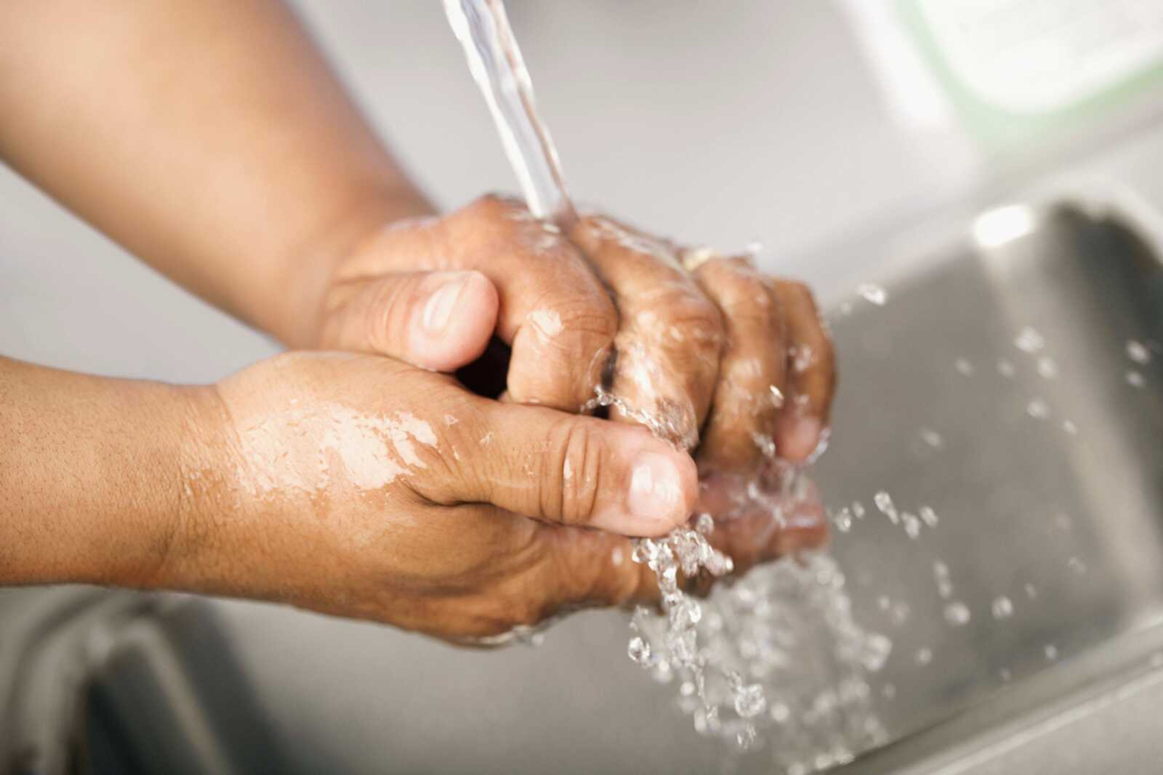 Healthcare worker washing hands in hospital