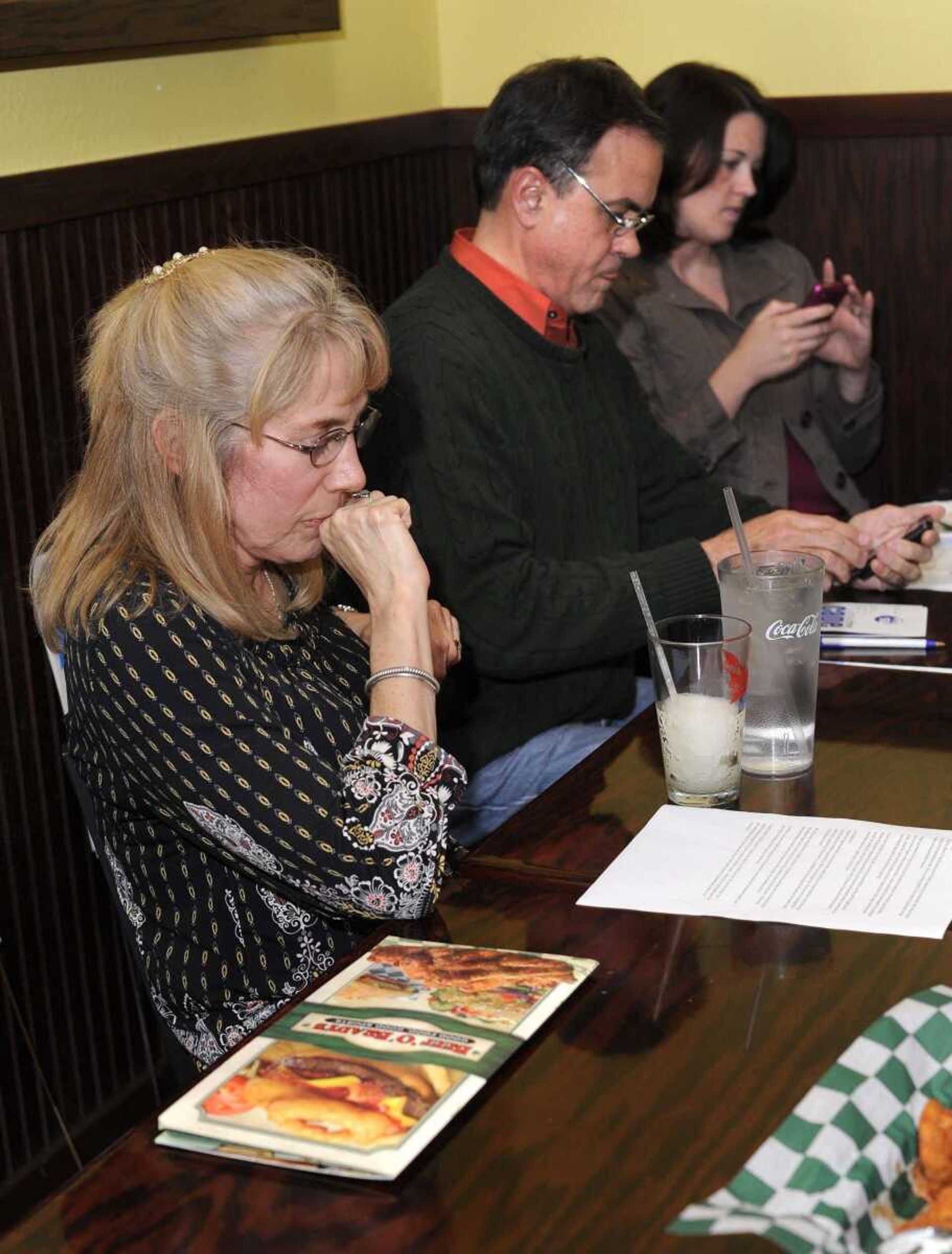 Dale Humphries, left, with Smoke-Free Cape reflects on the defeat of the smoking ban for Cape Girardeau after hearing the report from Stacy Reliford, right, a lobbyist with the American Cancer Society, Tuesday, April 5, 2011 at Beef O'Brady's. Dan Carrigan, center, also waited for election results. (Fred Lynch)