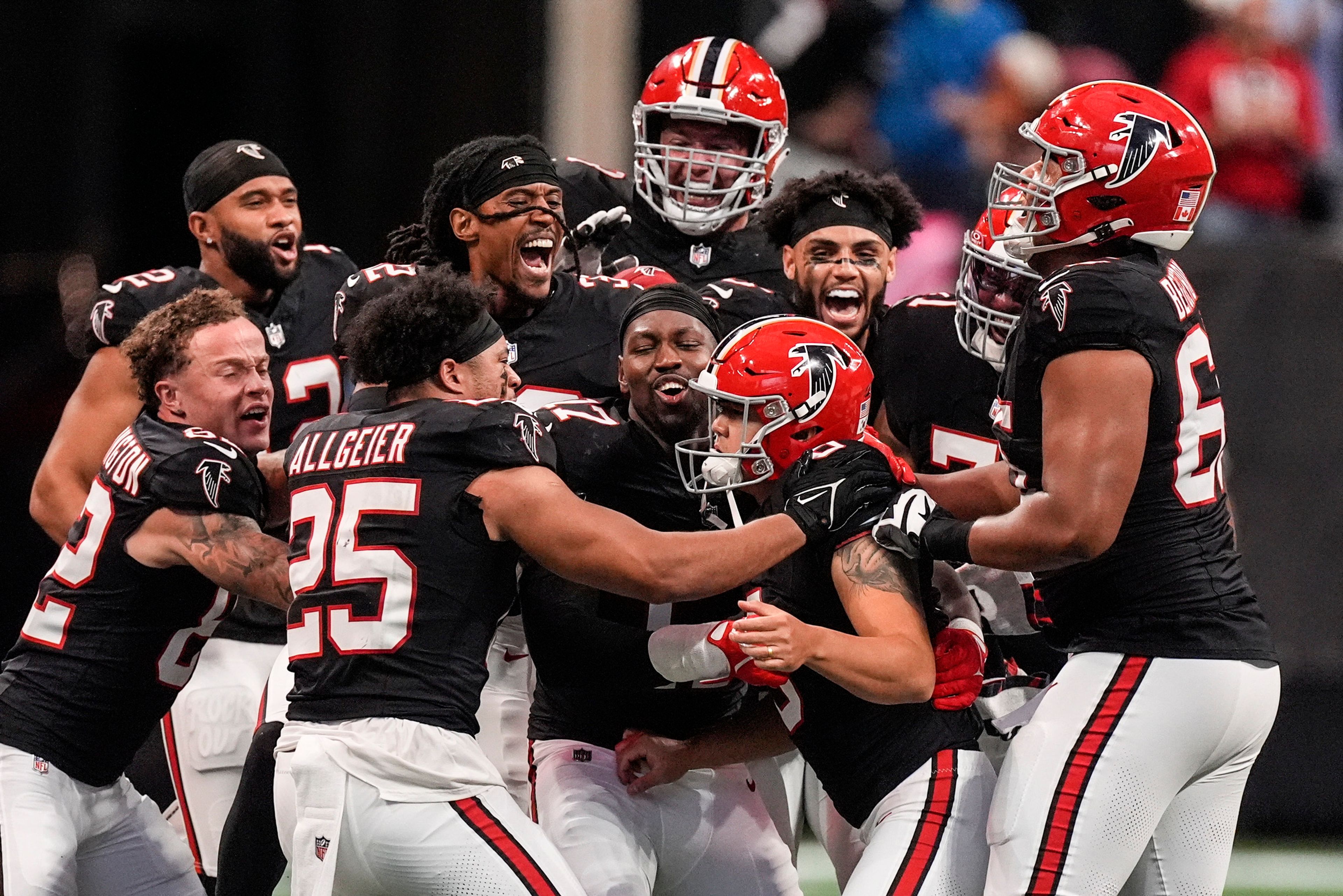 Atlanta Falcons players celebrate place kicker Younghoe Koo's game-winning 58-yard-field goal against the New Orleans Saints during the second half of an NFL football game, Sunday, Sept. 29, 2024, in Atlanta. (AP Photo/John Bazemore)