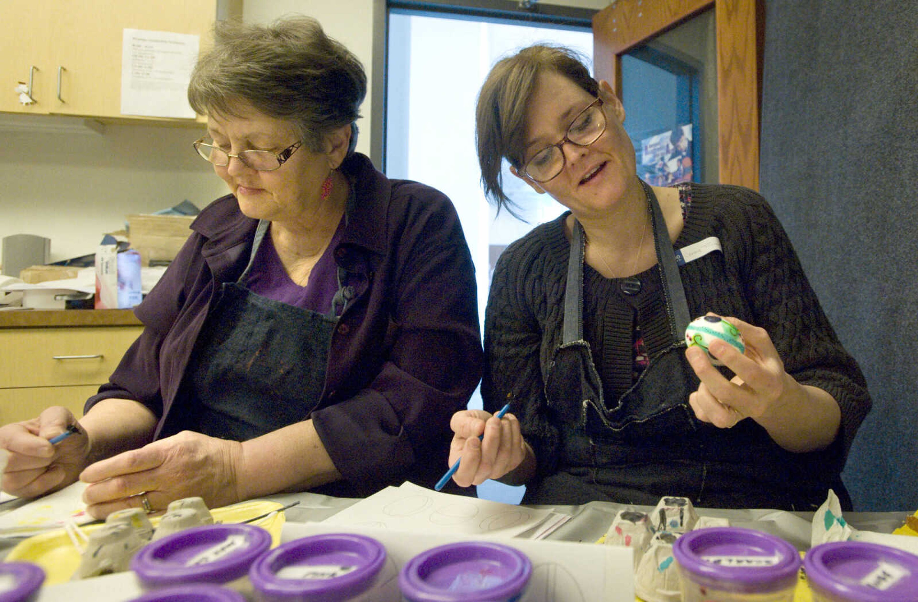 LAURA SIMON ~ lsimon@semissourian.com
Dodie Eisenhauer, left, and Jenny Turner apply dye to their eggs Tuesday, March 19, 2013 during the Wonderful World of Pysanky workshop at Southeast Missouri State University's River Campus.