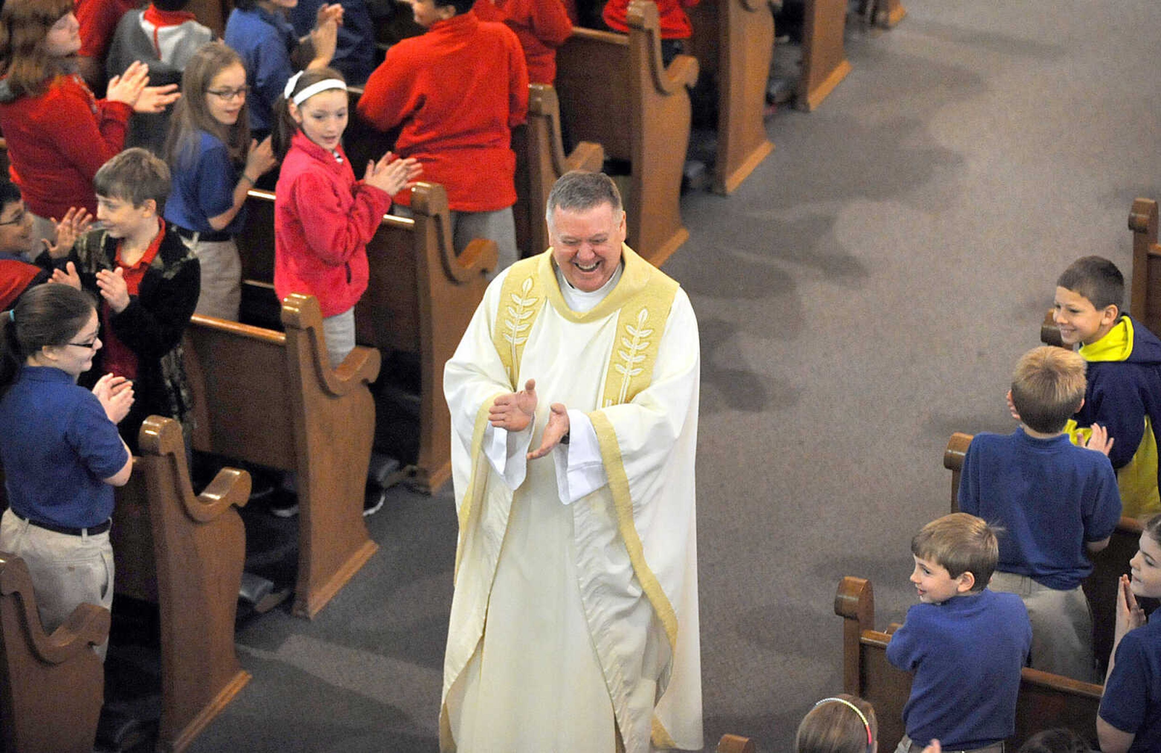 LAURA SIMON ~ lsimon@semissourian.com
Rev. Tom Kiefer and students of St. Mary Cathedral Grade School applaud the adults' participation in the singing of "Father, We Adore You" Friday morning, March 15, 2013 during the Mass of Thanksgiving at St. Mary's Cathedral in Cape Girardeau. The mass was in honor of the election of Pope Francis I.