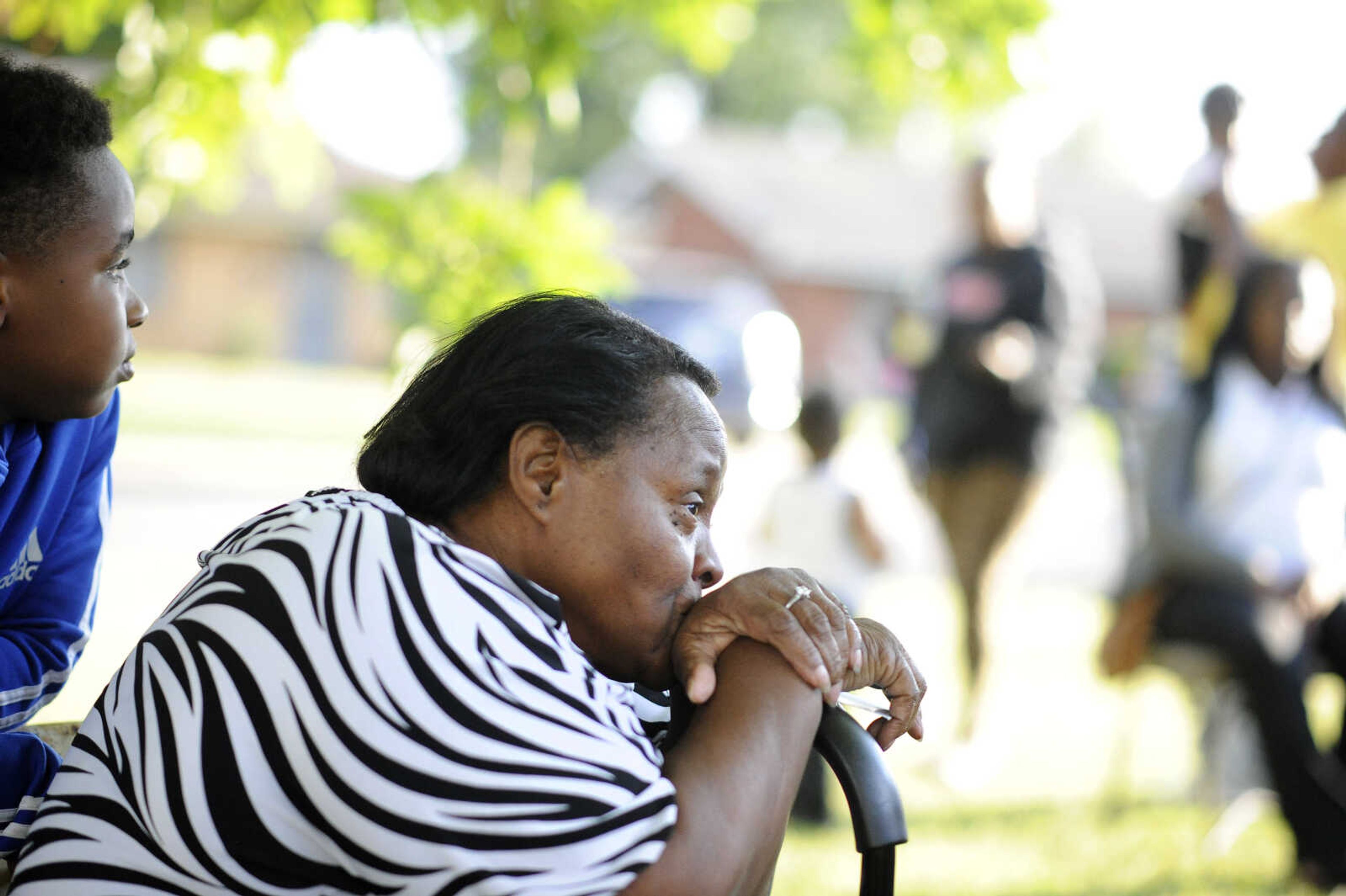 LAURA SIMON ~ lsimon@semissourian.com

Jennett McCaster, David Robinson's mother, listens as her son Justin is interviewed by the Southeast Missourian about his brother outside McCaster's Sikeston, Missouri home in September.