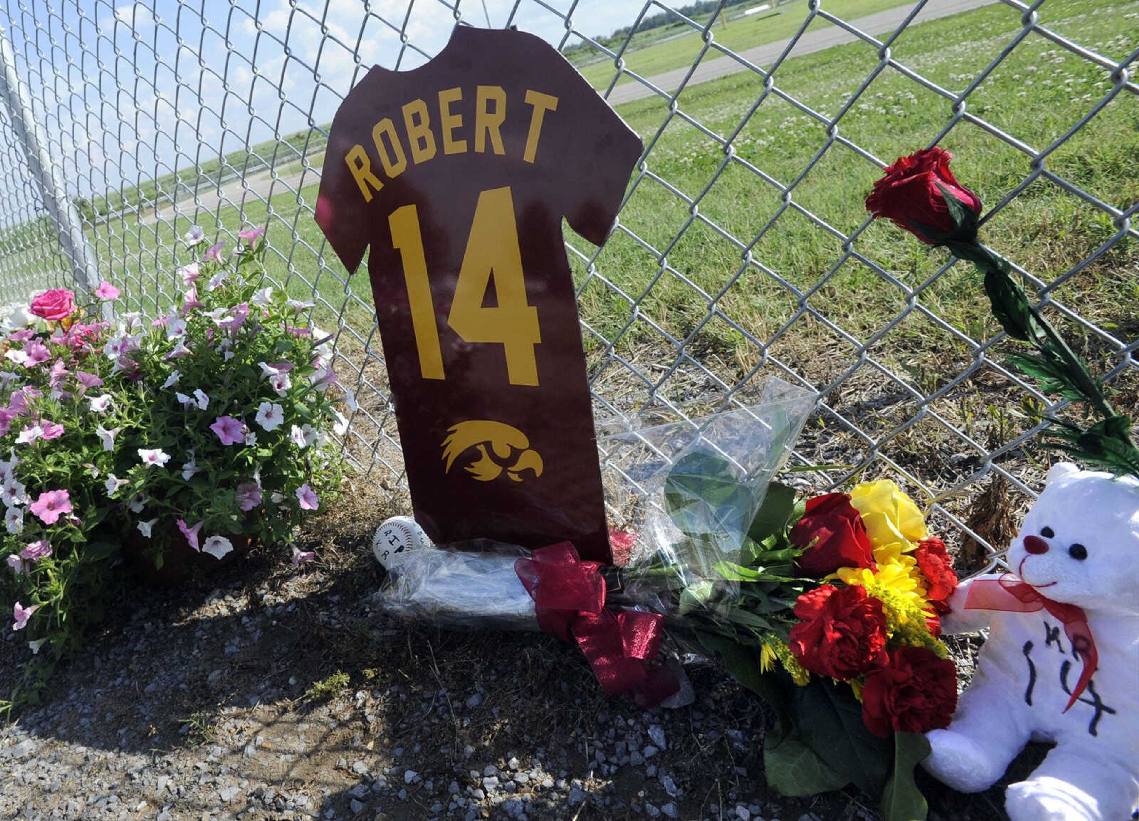 People left items along the fence in memory of Kaden Robert as they entered the football field Tuesday at Kelly High School near Benton, Missouri. (Fred Lynch)