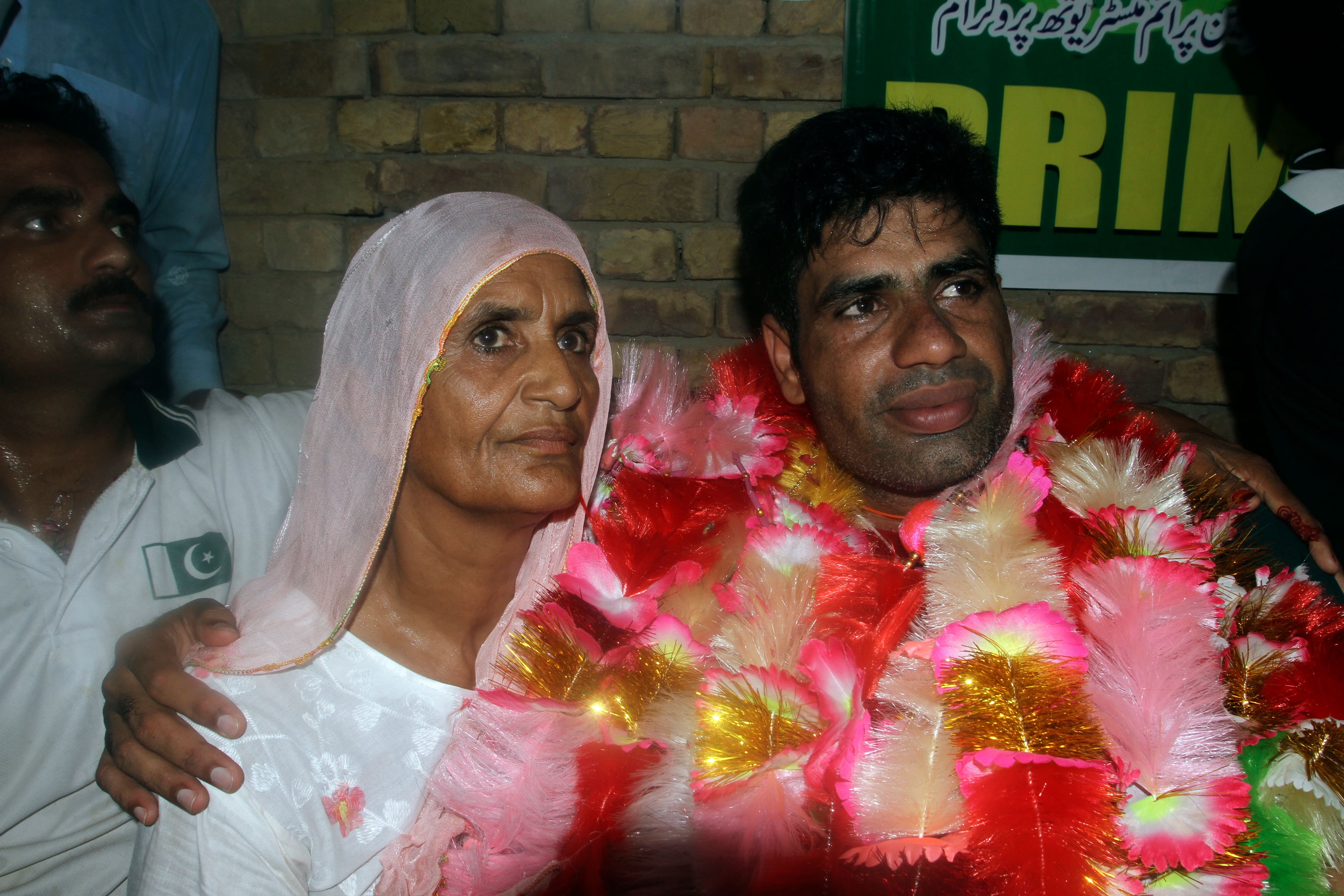 Men's javelin gold medalist, Arshad Nadeem, of Pakistan Arshad Nadeem poses for a photograph with his mother inside his house, in Mian Channu, Khanewal district, of Pakistan, Sunday, Aug. 11, 2024. (AP Photo/Asim Tanveer)