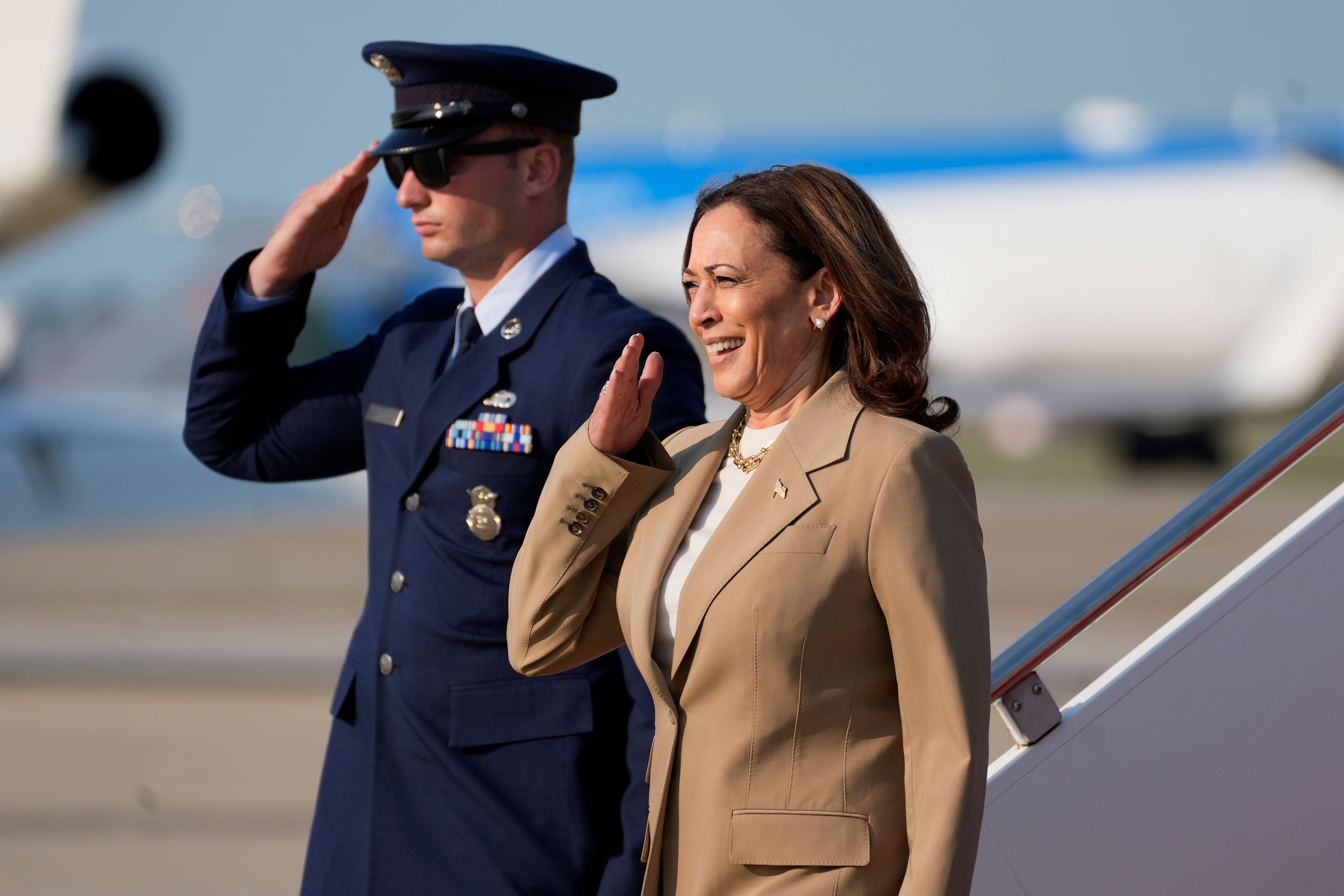 Vice President Kamala Harris, right, salutes upon arrival at Andrews Air Force Base in Md., Saturday, July 27, 2024. Harris is returning to Washington after participating in a political event in Pittsfield, Mass. (AP Photo/Stephanie Scarbrough, Pool)