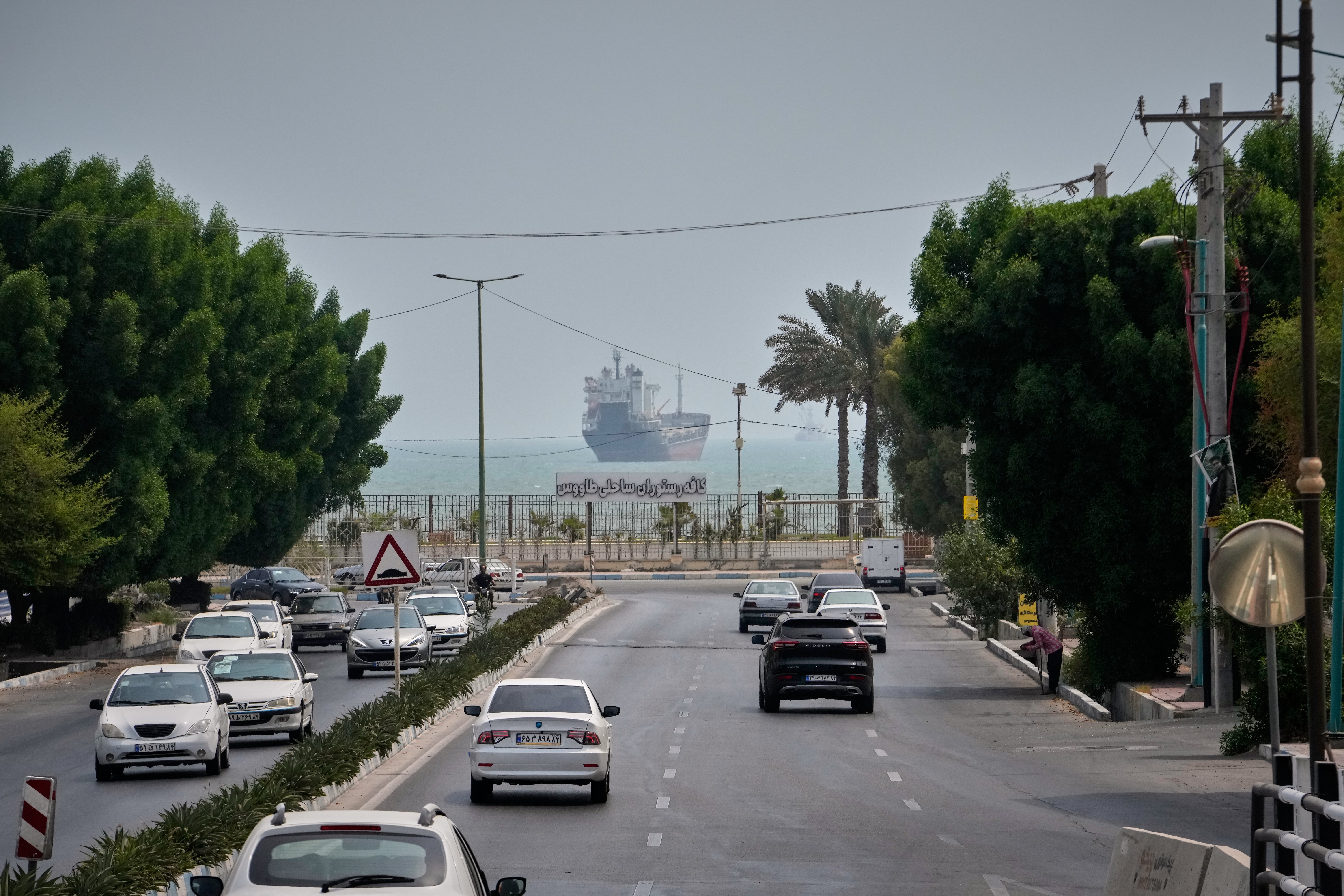 Photos show daily life in Iran on the beach along the Strait