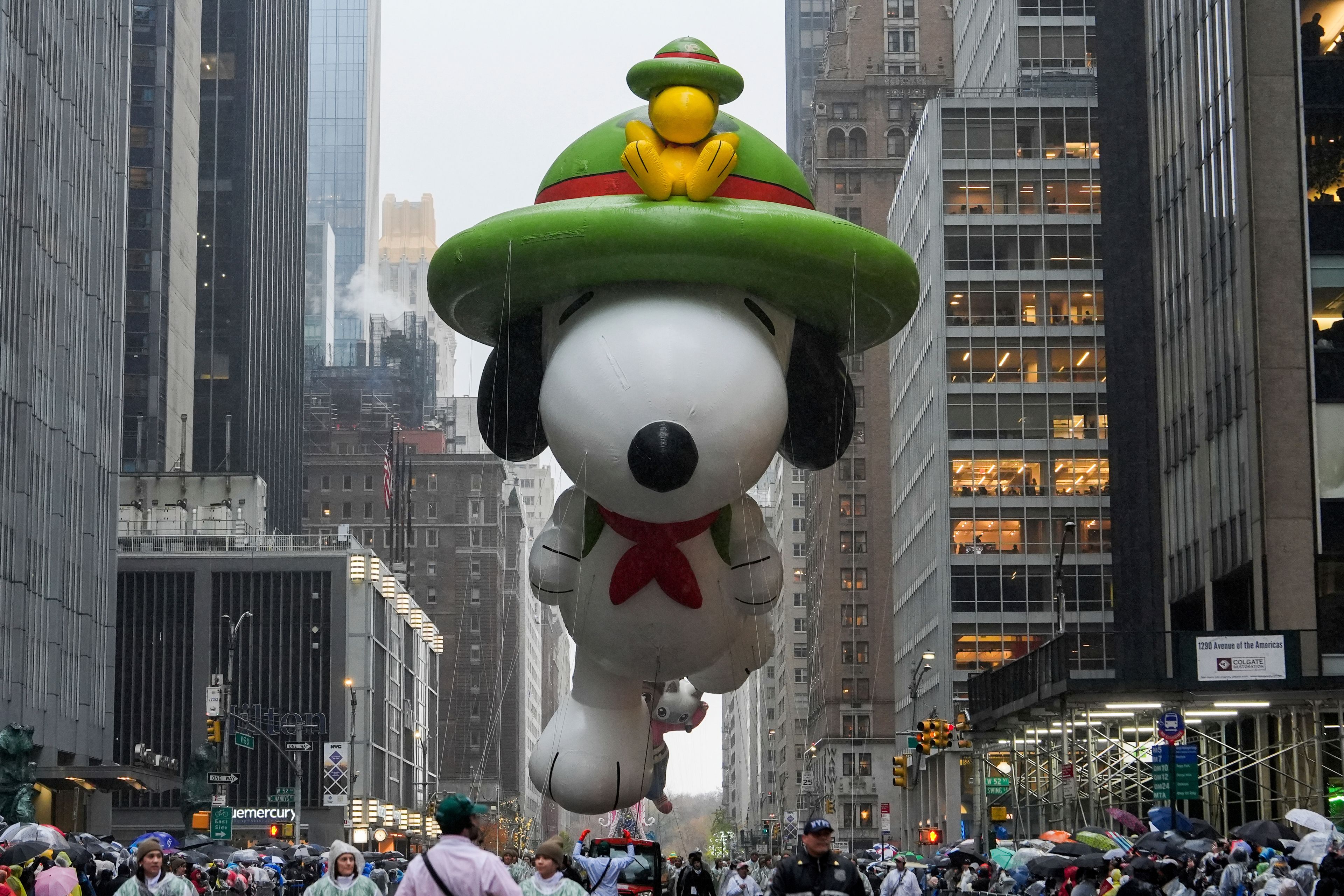 Handlers guide the Snoopy balloon down Sixth Avenue during the Macy's Thanksgiving Day Parade, Thursday, Nov. 28, 2024, in New York. (AP Photo/Julia Demaree Nikhinson)