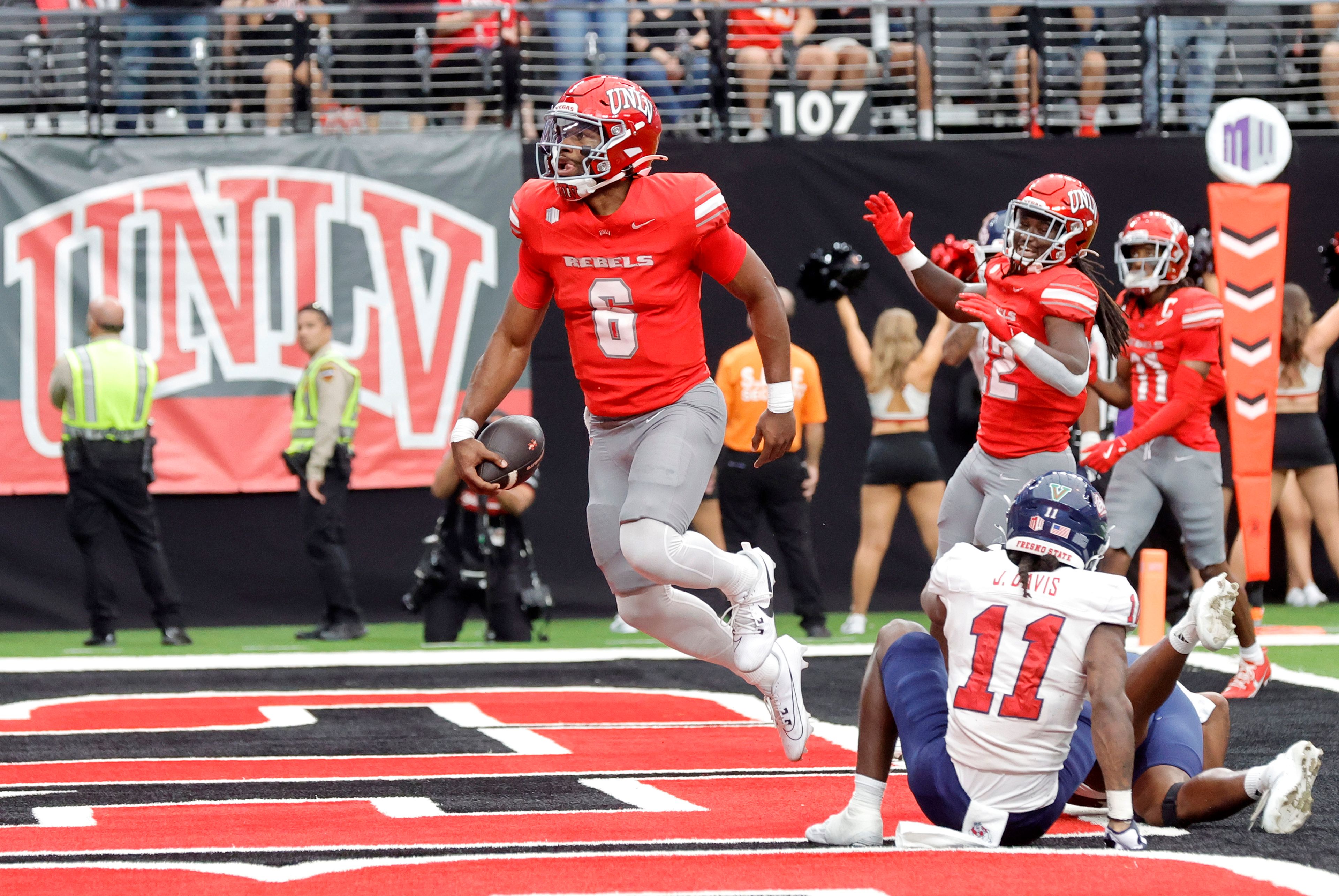 CORRECTS ID TO QUARTERBACK HAJJ-MALIK WILLIAMS, NOT RUNNING BACK JAI'DEN THOMAS - UNLV quarterback Hajj-Malik Williams (6) celebrates after running for a touchdown past Fresno State defensive back Jayden Davis (11) during the first half of a NCAA football game, Saturday, Sept. 28, 2024, in Las Vegas. (Steve Marcus/Las Vegas Sun via AP)