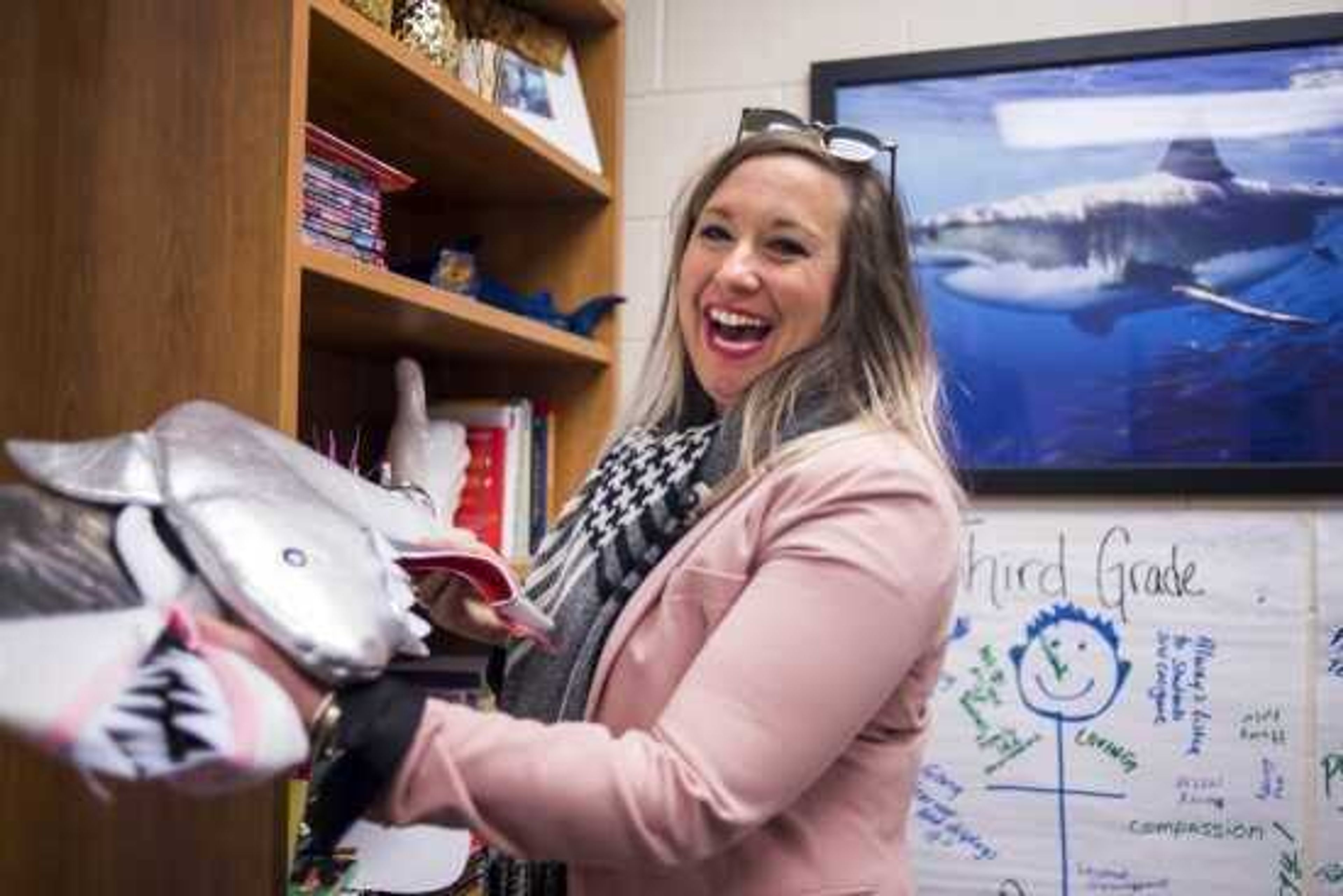 Jefferson Elementary School principal Leigh Ragsdale laughs while rummaging through shark decorations and shark-themed gifts she's received in her office after completing her morning rounds Friday in Cape Girardeau.

TYLER GRAEF

