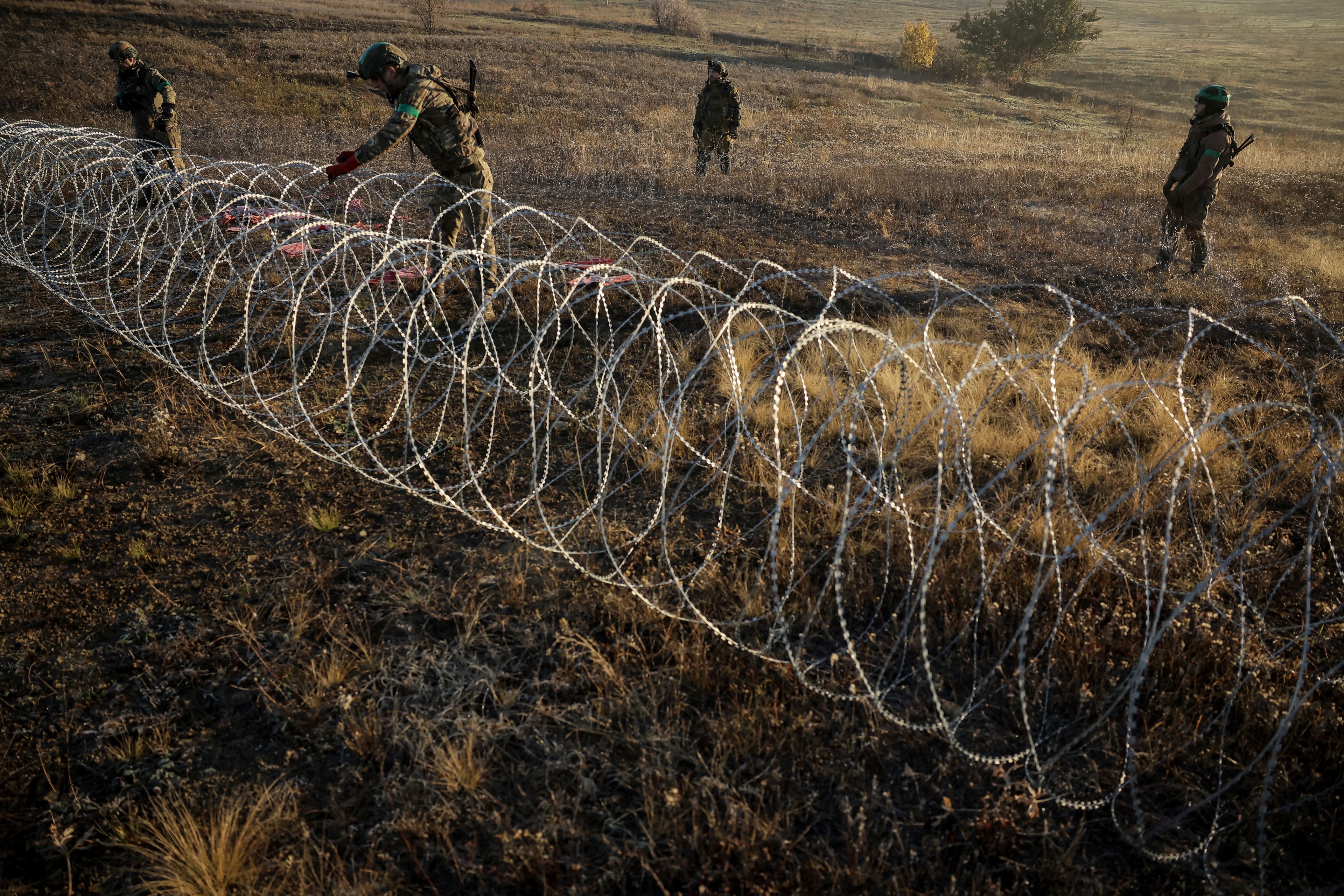 In this photo provided by Ukraine's 24th Mechanised Brigade press service, servicemen of the 24th Mechanised Brigade install anti-tank landmines and non explosive obstacles along the front line near Chasiv Yar town in Donetsk region, Ukraine, Wednesday Oct. 30, 2024. (Oleg Petrasiuk/Ukrainian 24th Mechanised Brigade via AP)