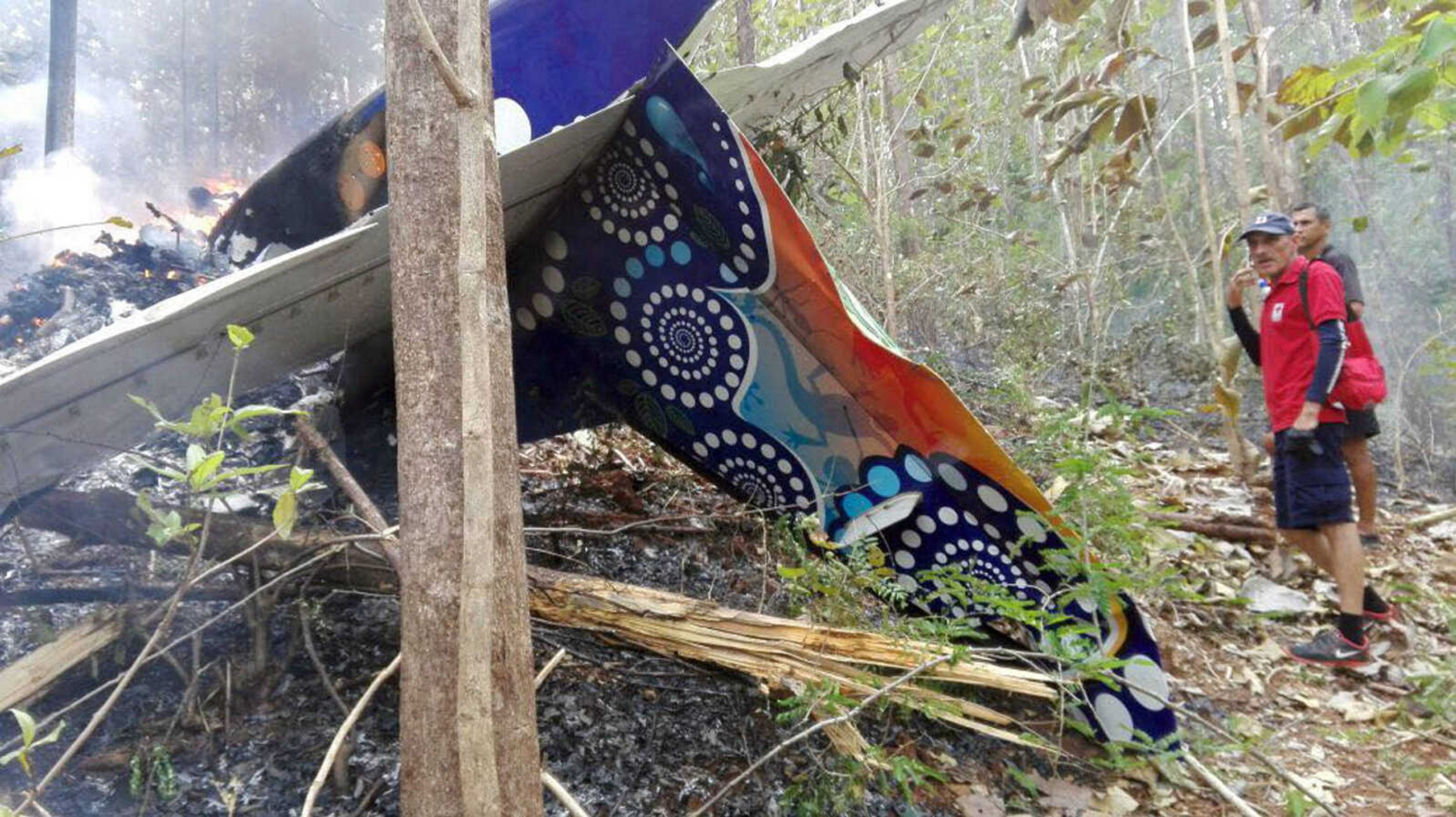 This photo shows people standing at the site of a plane crash Sunday in Punta Islita, Guanacaste, Costa Rica.