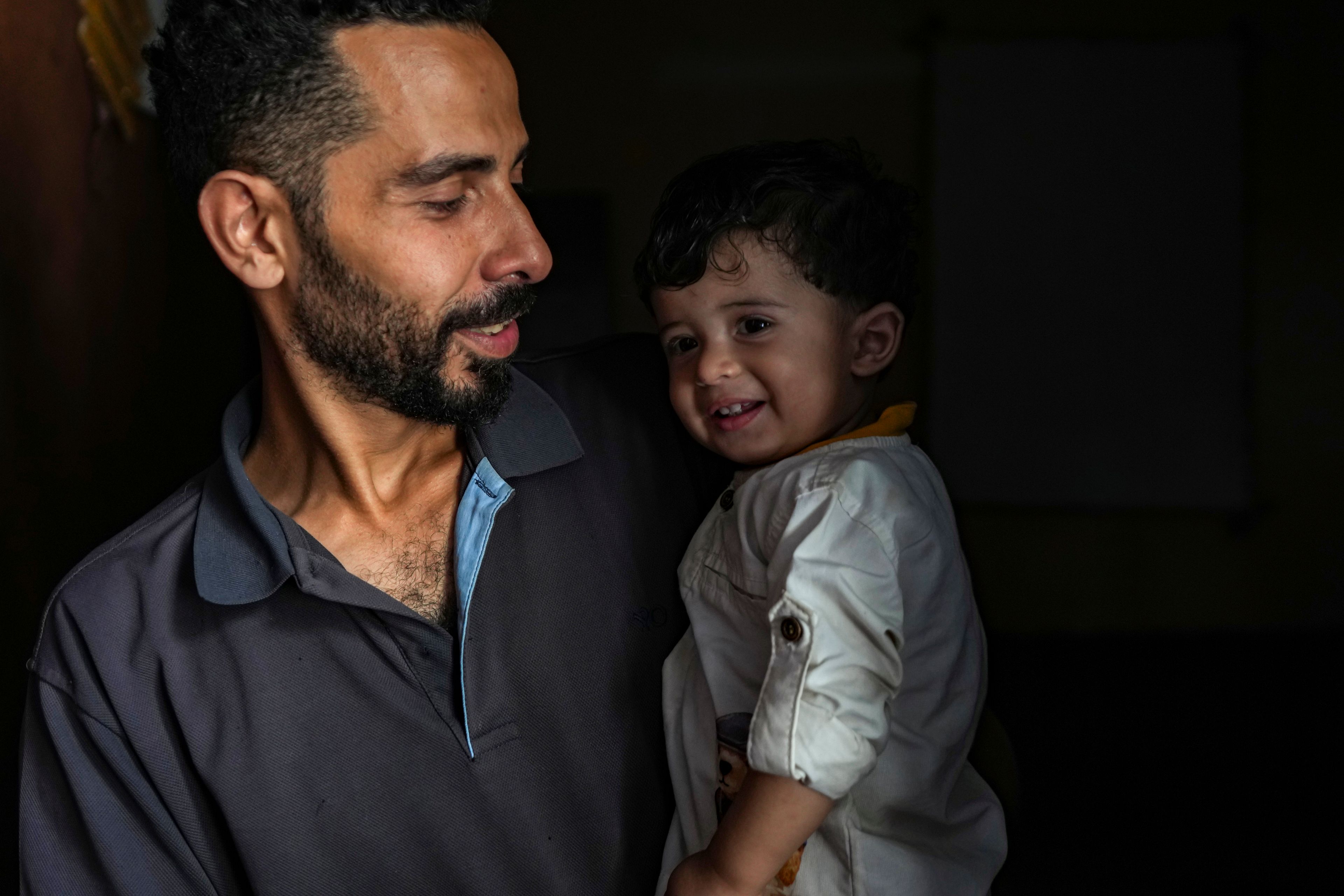 Mustafa Al-Taweel holds his child Ali, who was born on October 7, at his family home in Nuseirat, as the Israeli-Hamas war marks its one year anniversary, Gaza Strip, Saturday, Oct. 5, 2024. (AP Photo/Abdel Kareem Hana)