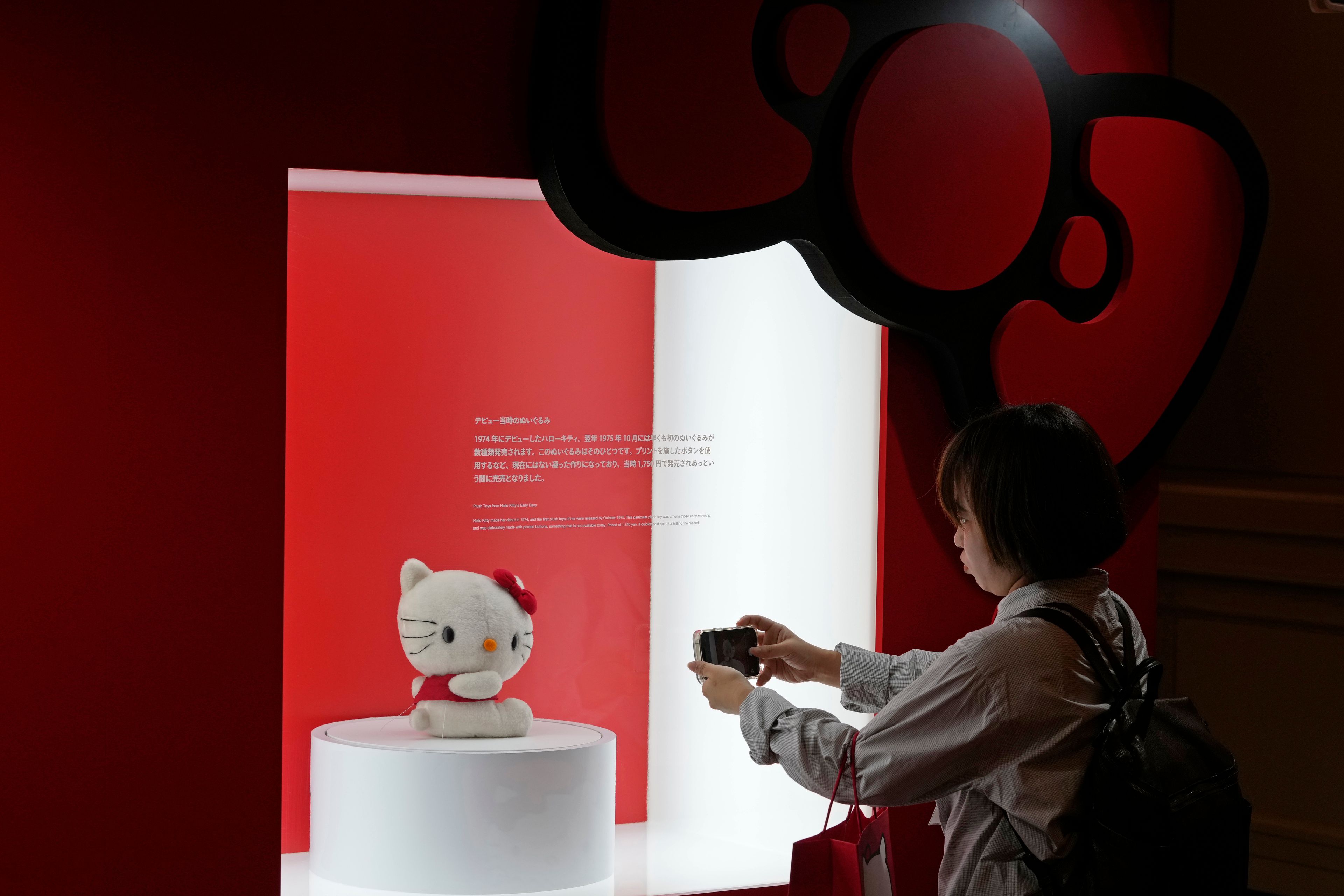 A visitor takes a picture of a Hello Kitty doll at the exhibition "As I change, so does she," marking the 50th anniversary of Hello Kitty at the Tokyo National Museum in Tokyo Wednesday, Oct. 30, 2024. (AP Photo/Shuji Kajiyama)