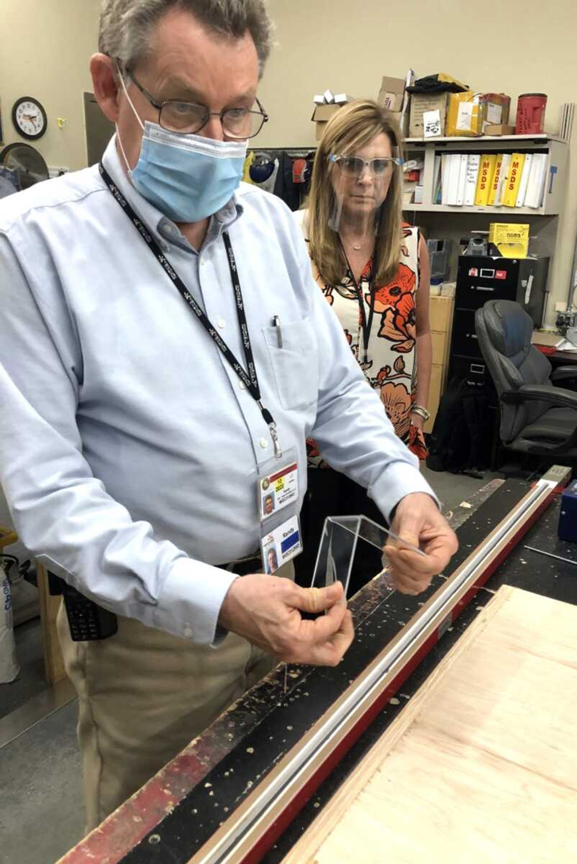 Century Casino Cape Girardeau facility manager Randy Powders bends a component for one of the casino's acrylic table-game partitions. Watching is Lisa McMahan, marketing director for the Century Casino locations in Cape Girardeau and Caruthersville, Missouri.