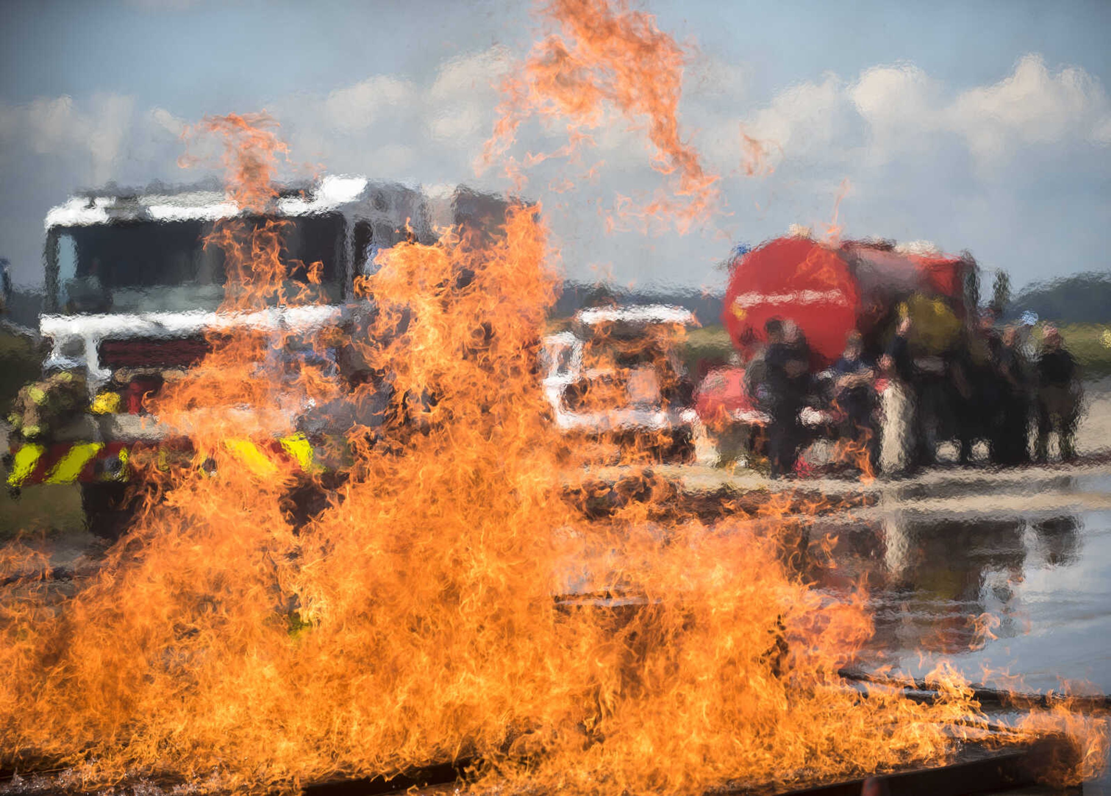 A firefighter guiding a firetruck hose puts out a ground fire and aircraft fire while area firefighters from Cape Girardeau, Gordonville and Scott City run airplane fire drills at the Cape Girardeau Regional Airport Friday morning, Sept. 15, 2017 in Cape Girardeau.